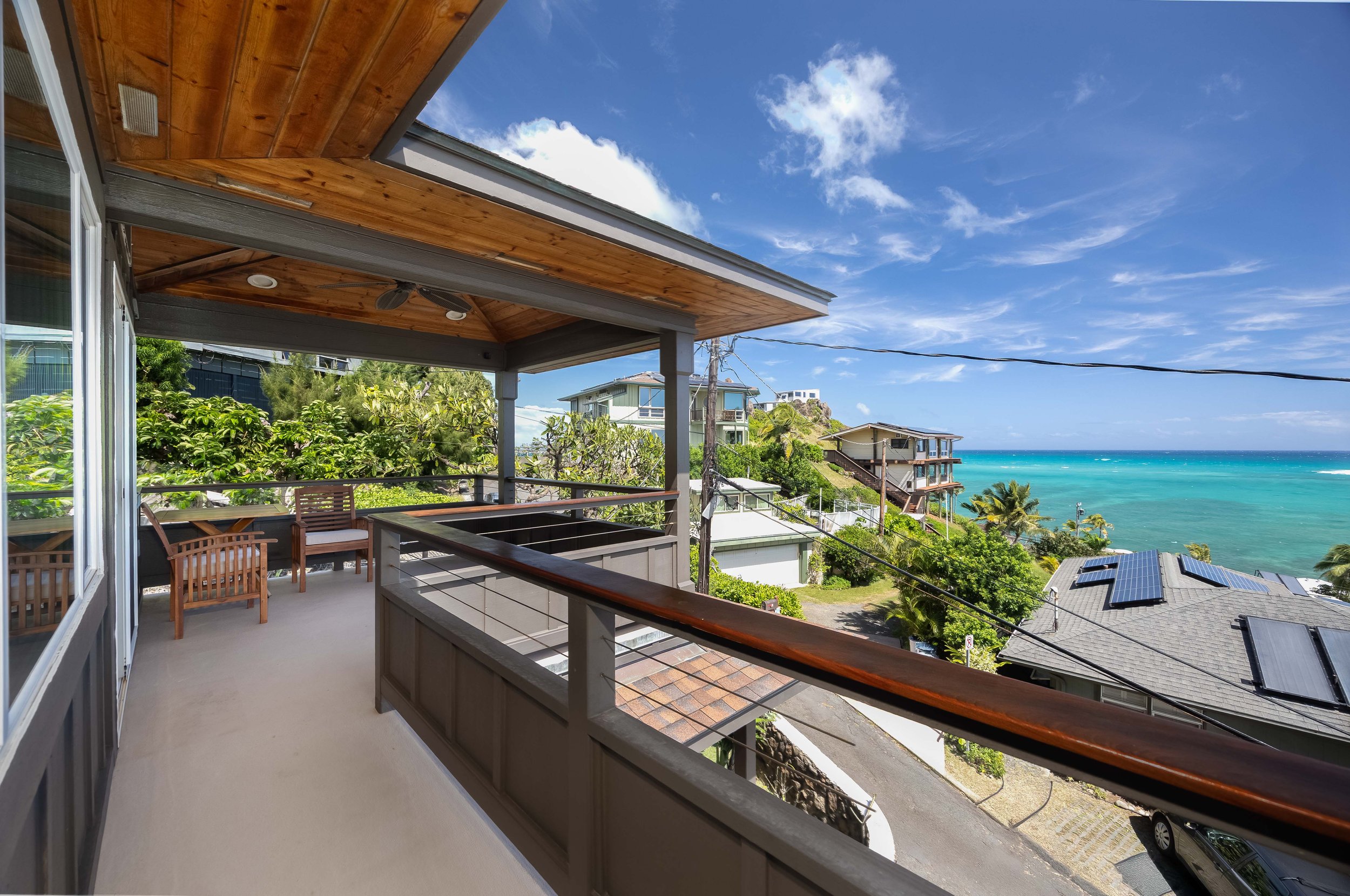 Covered wraparound lanai on the 2nd floor with sitting areas and beautiful views