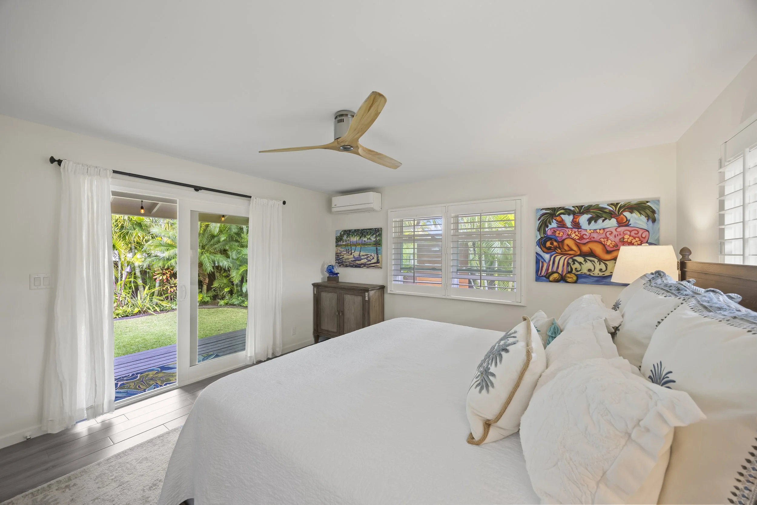 Primary bedroom suite with a large sliding glass door opening directly to the covered lanai
