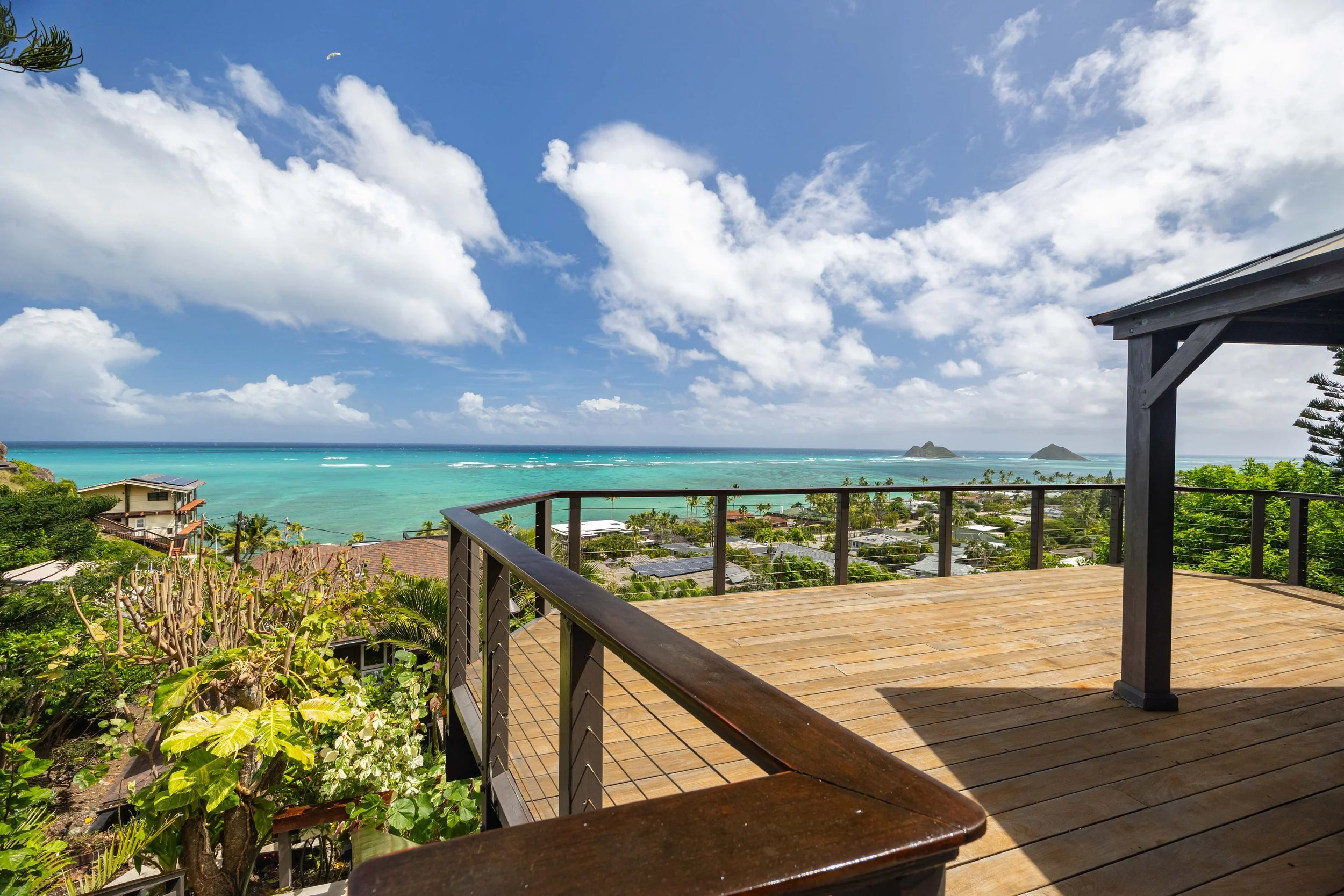 Experience breathtaking ocean and Mokulua Islands views from this exquisite Lanikai hillside residence.
