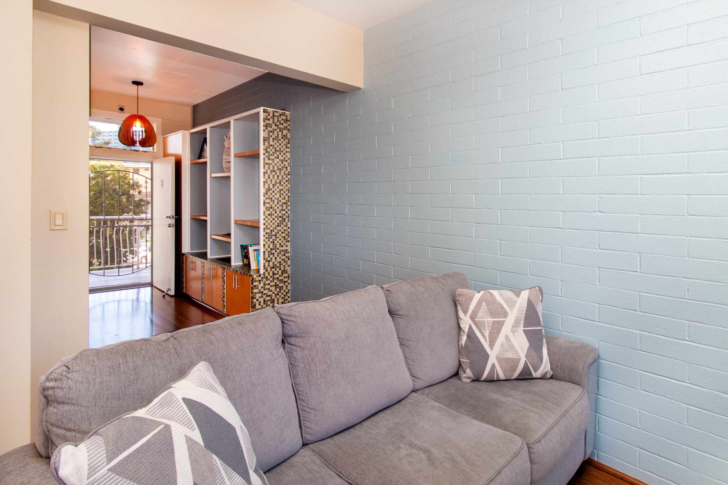 An entrance with a screen door and a built-in shelf/ closet provides additional storage.