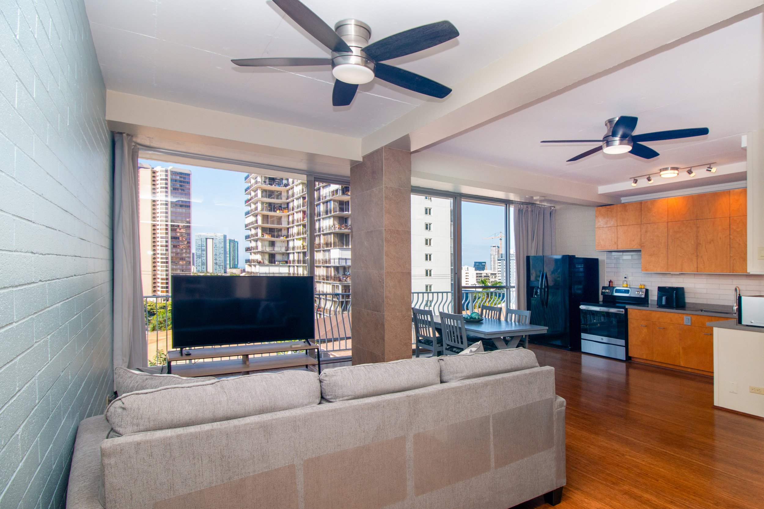 Living area and open kitchen with city views.