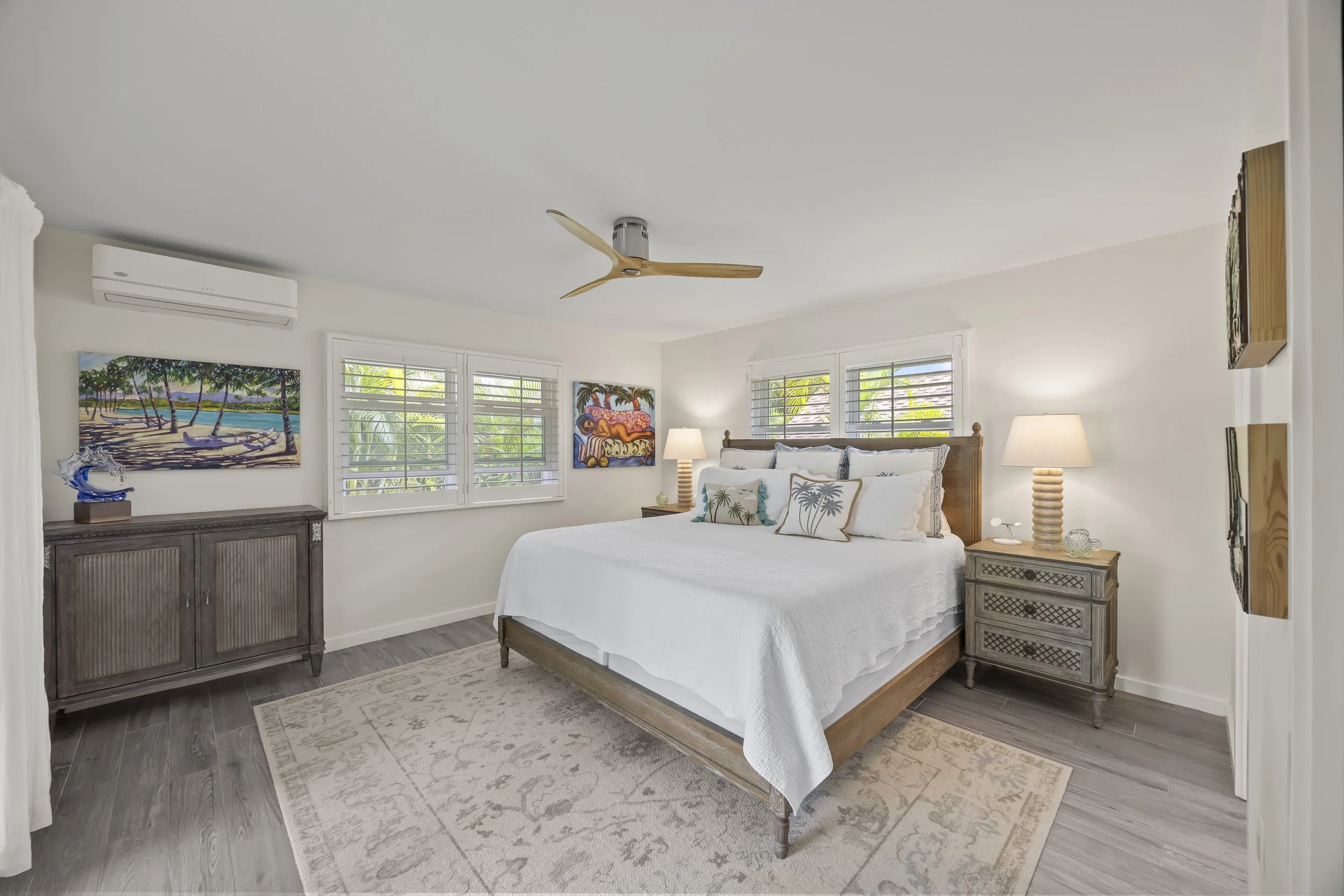 Primary bedroom suite with a large sliding glass door opening directly to the covered lanai