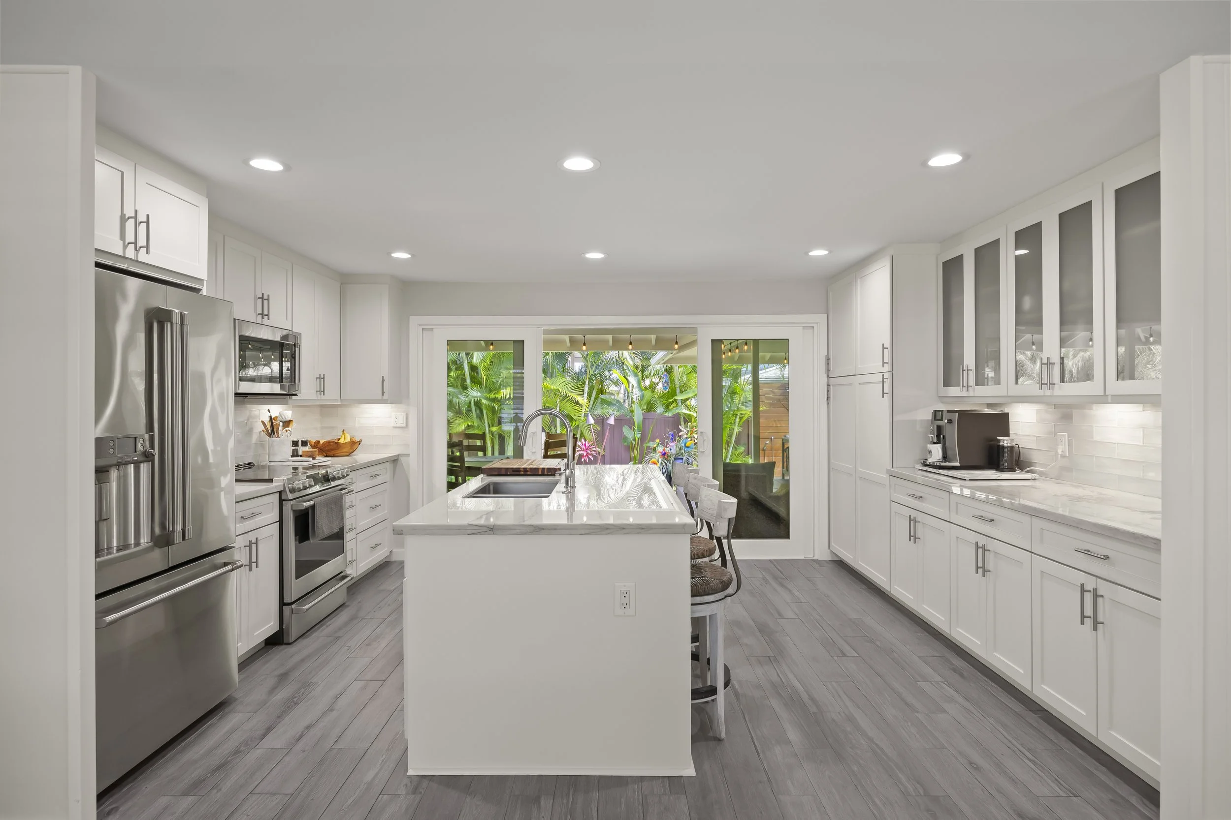 This beautifully upgraded residence offers seamless indoor-outdoor living with a dramatic 12-foot double sliding glass door opening to a spacious covered lanai