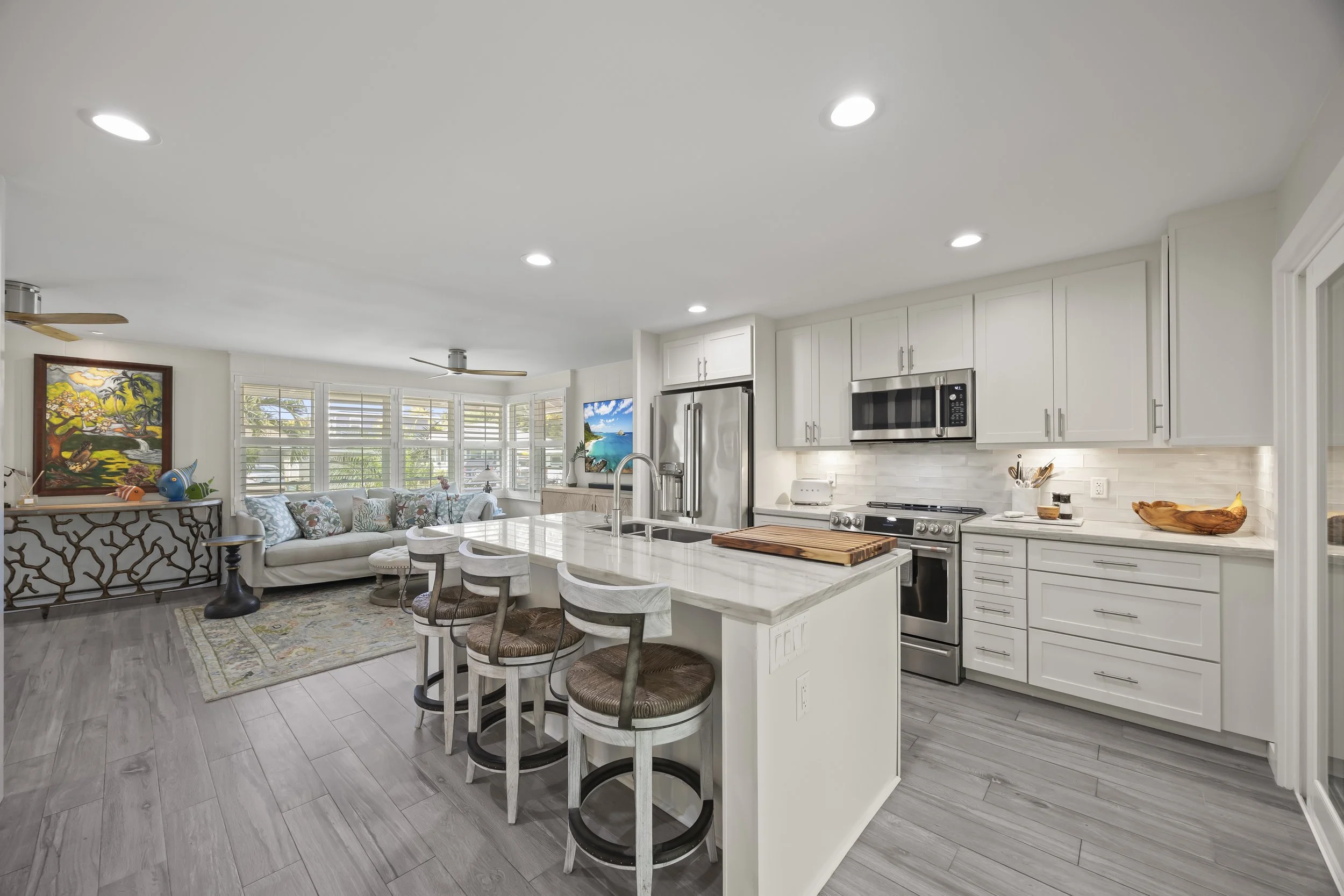 The open-plan design seamlessly connects the kitchen and island to the main living area 