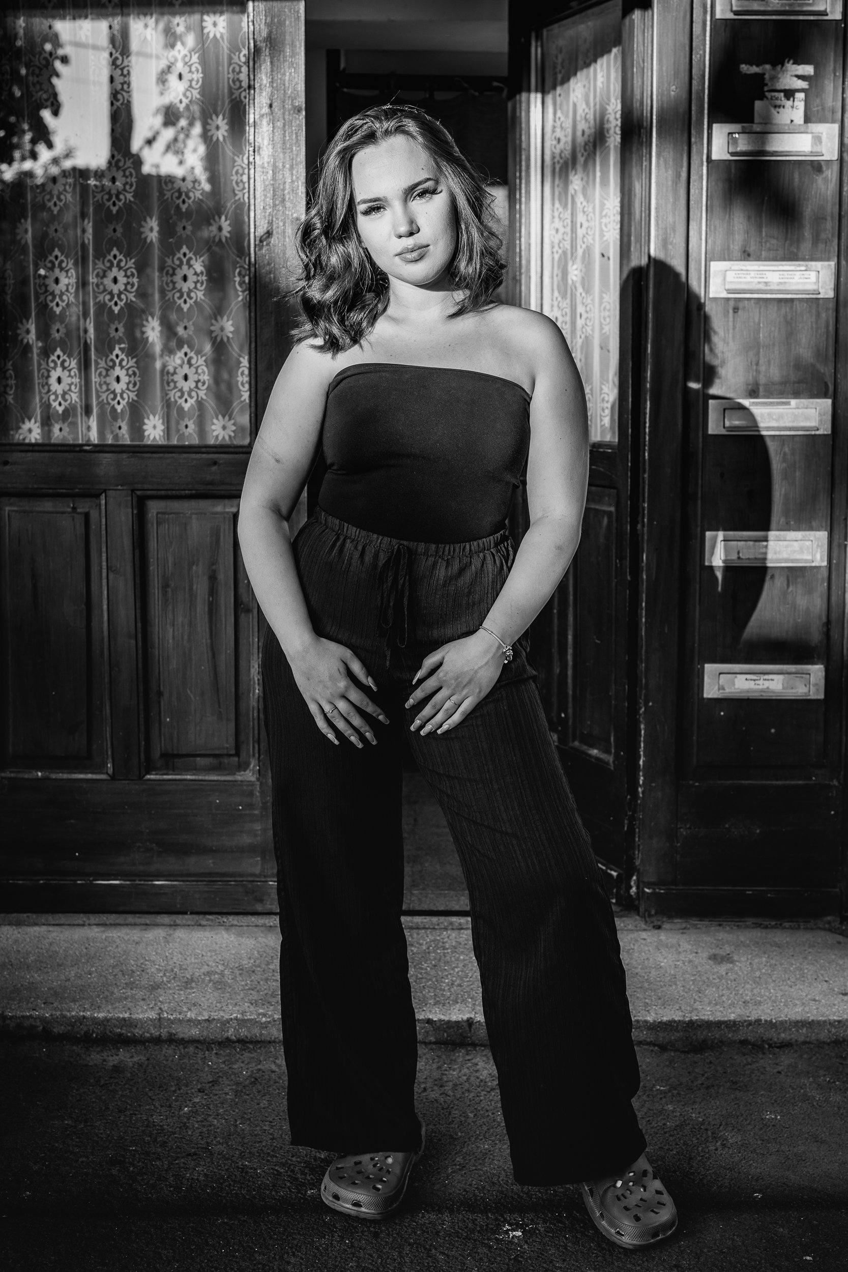 A young lady in front of their staircase