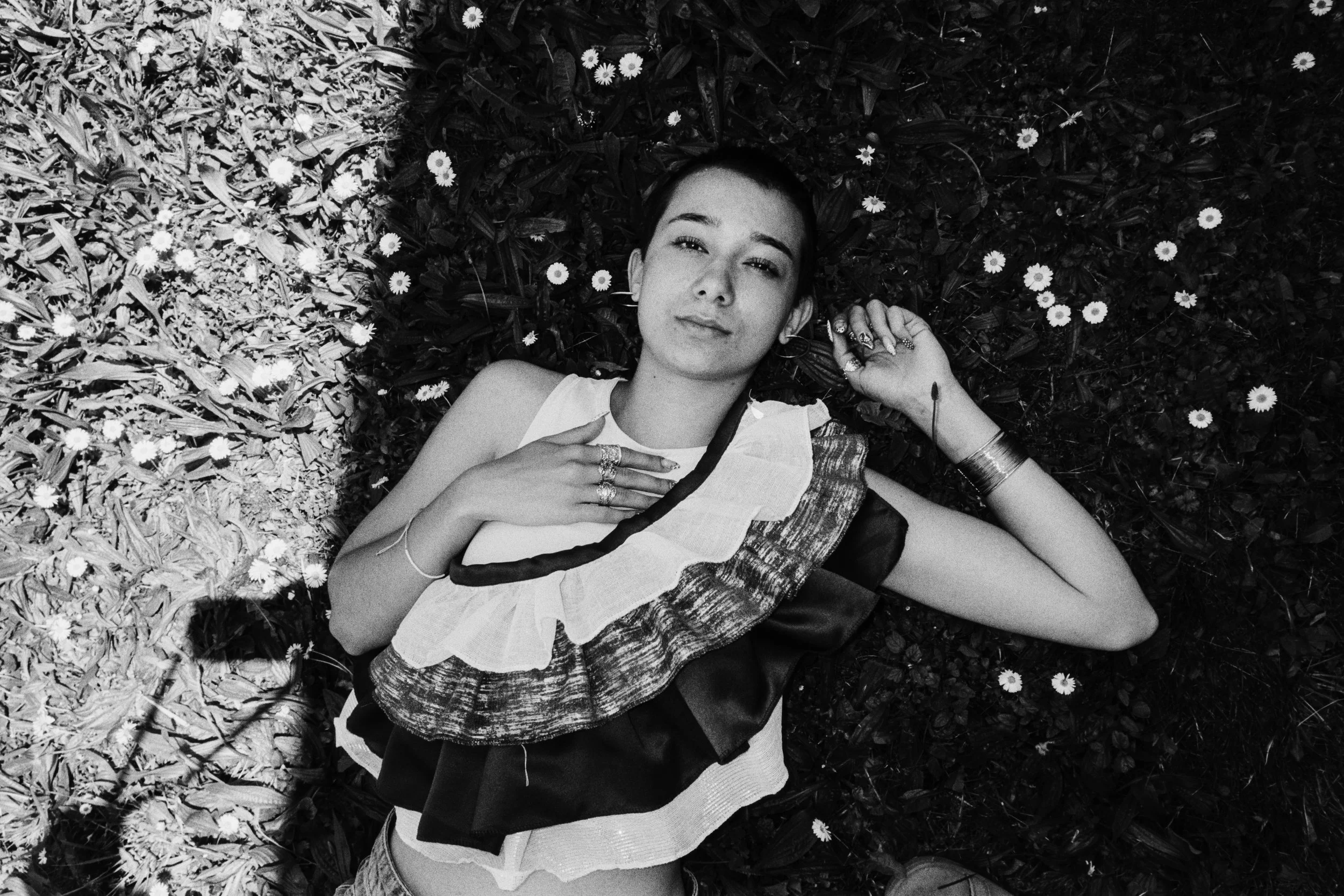 Izabell is lying on the grass wearing a top made by her friend. 2026.