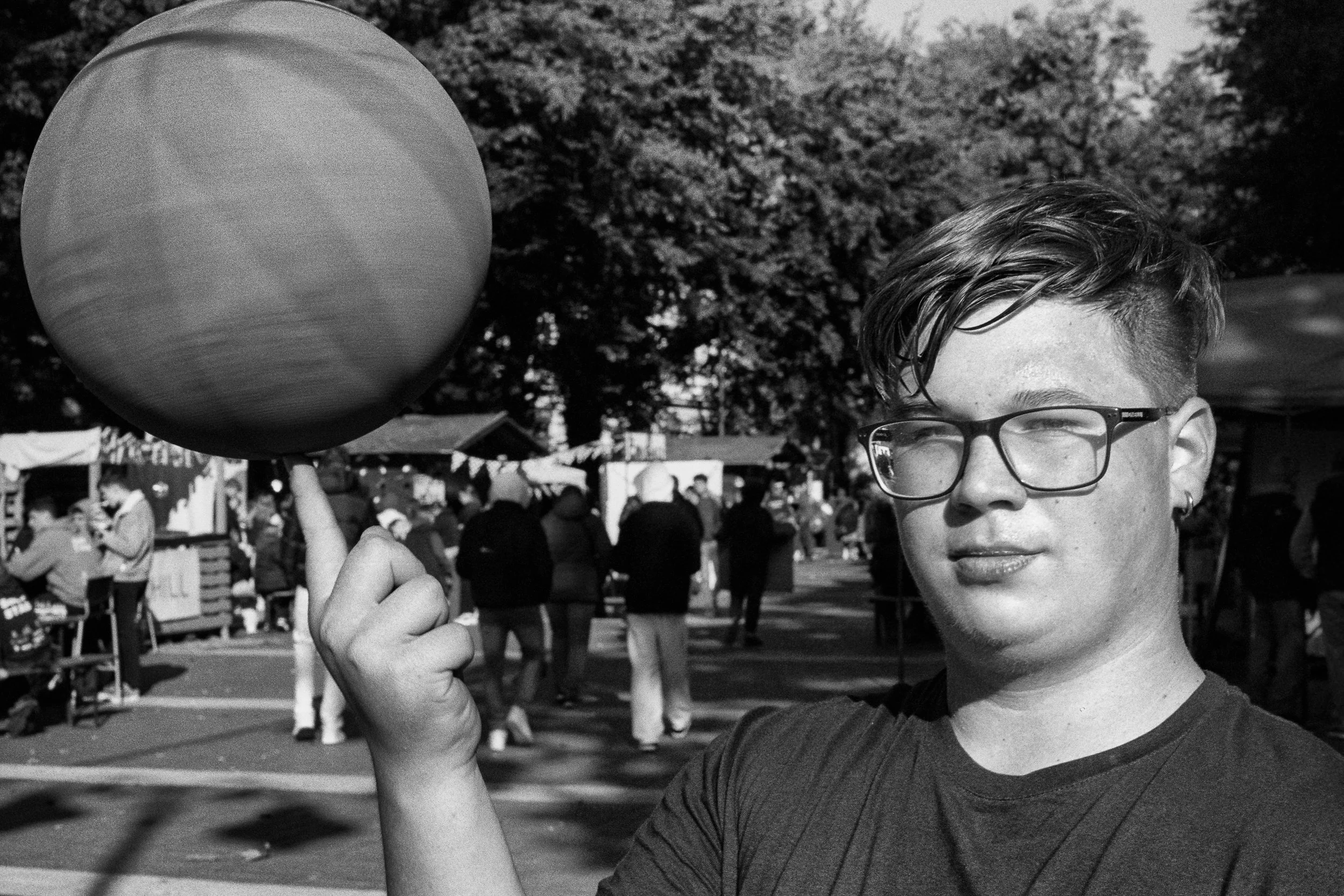A participant at a local youth festival spins a basketball on his finger. 2025.