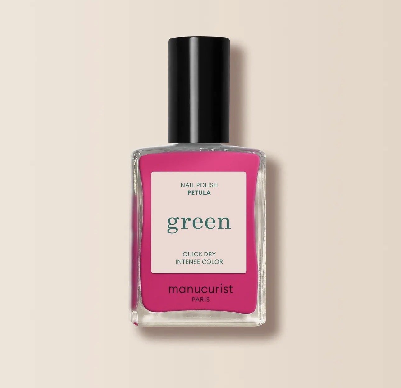 A bottle of Manucurist  pink nail polish with a black cap, labeled "green" and "manucurist Paris," placed on a neutral background.