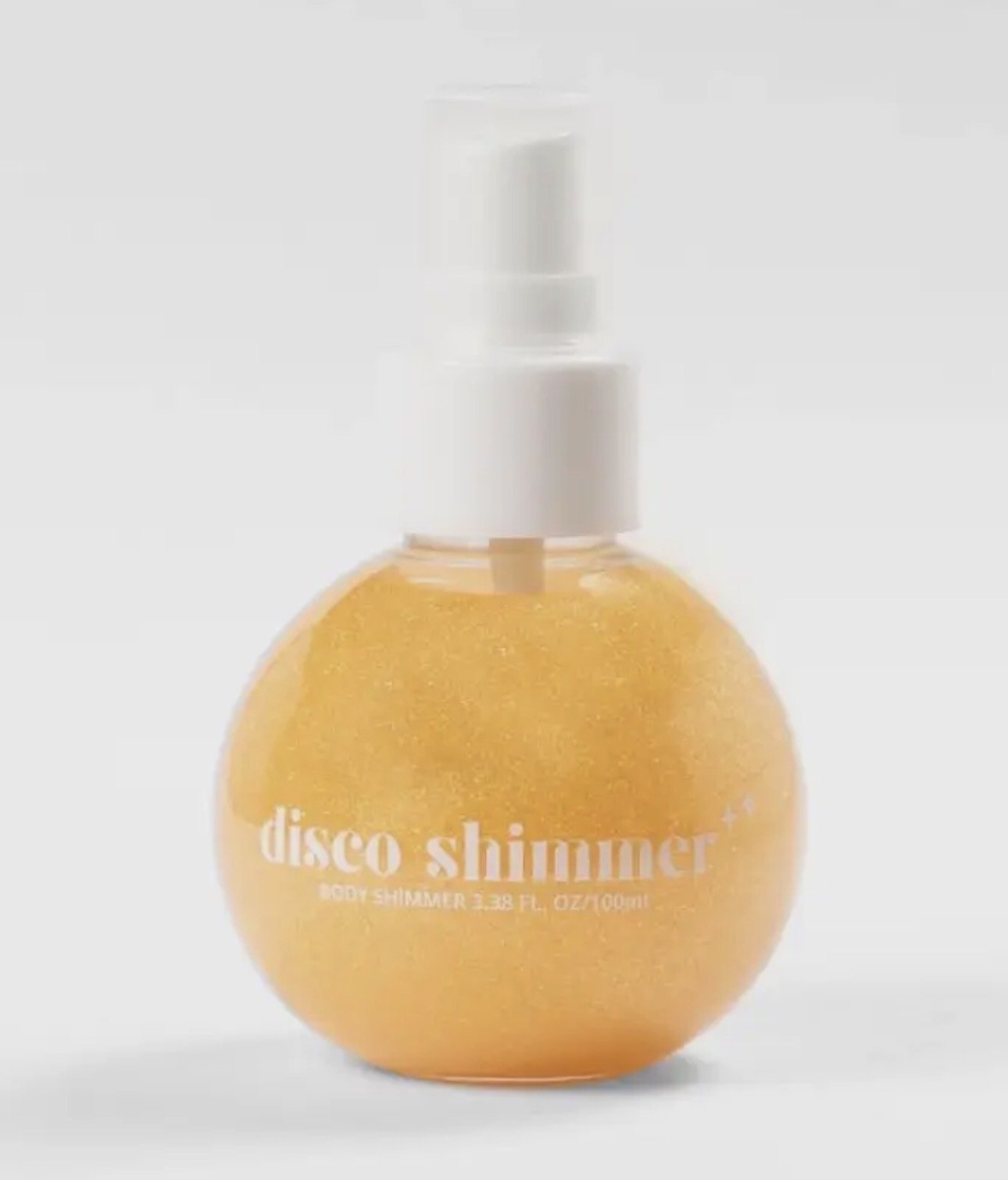 A clear spray bottle shaped like an orange with a white spray nozzle, labeled 'Lavender Stardust disco shimmer' body shimmer, 3.3 fluid ounces.