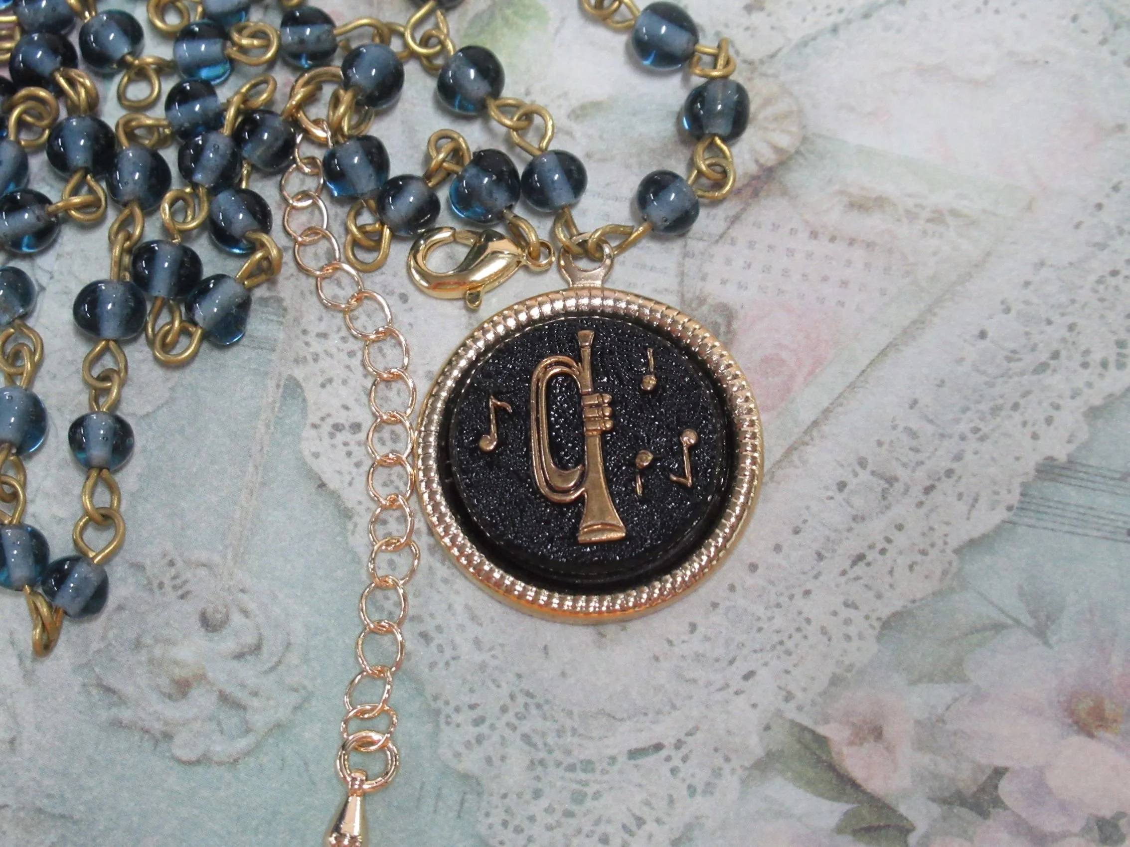 Rosies Vintage and Nik Naks Handcrafted Vintage Musical Trumpet Black Gold Charm Necklace Blue Glass Beaded Chain.
