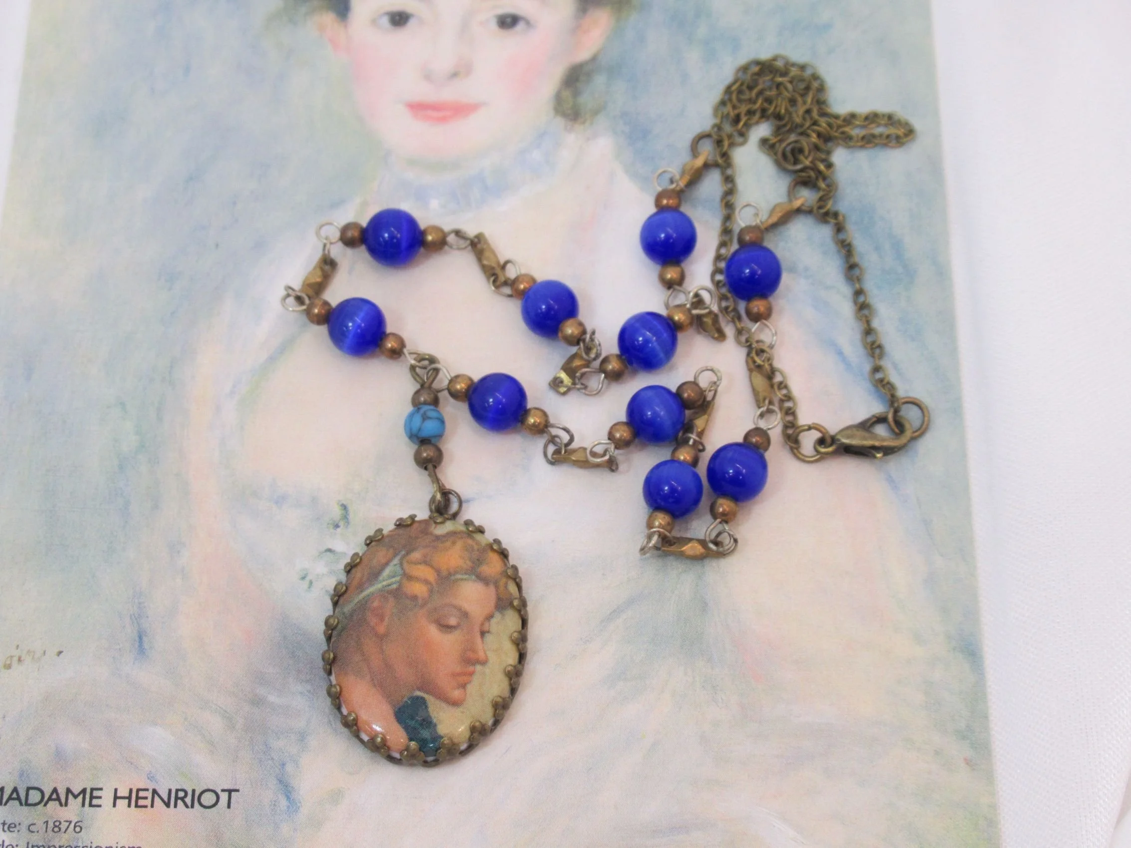 Rosies Vintage and Nik Naks Handcrafted Renaissance Inspired Michelangelo's Creation of Adam Blue Glass Bead Necklace.