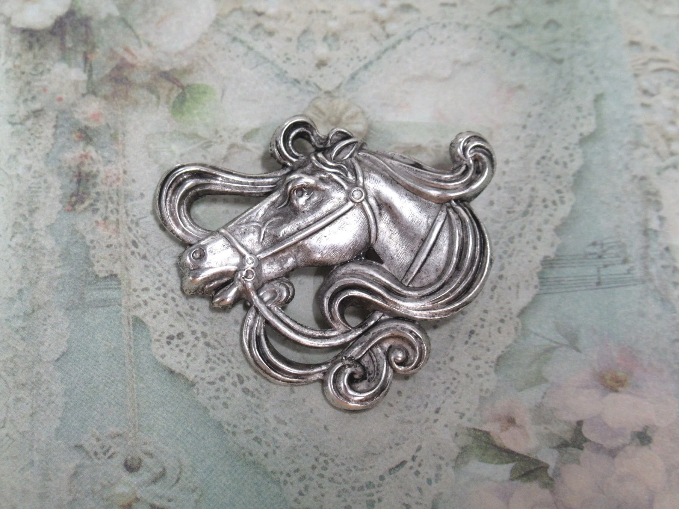 Rosies Vintage and Nik Naks Shop our vintage silver-tone horse head brooch. Detailed filigree mane profile pin perfect for western wear, lapels, and equestrian style enthusiasts.