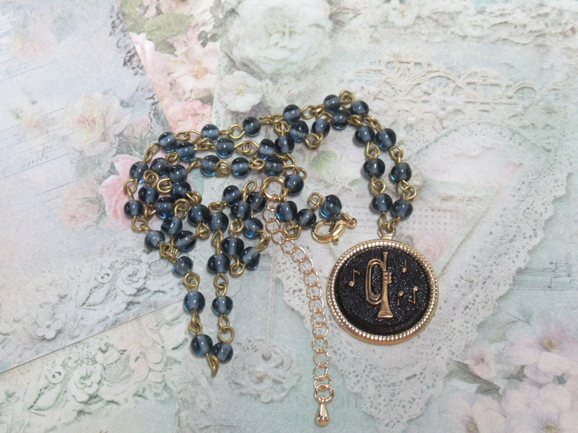 Rosies Vintage and Nik Naks Handcrafted Vintage Musical Trumpet Black Gold Charm Necklace Blue Glass Beaded Chain.