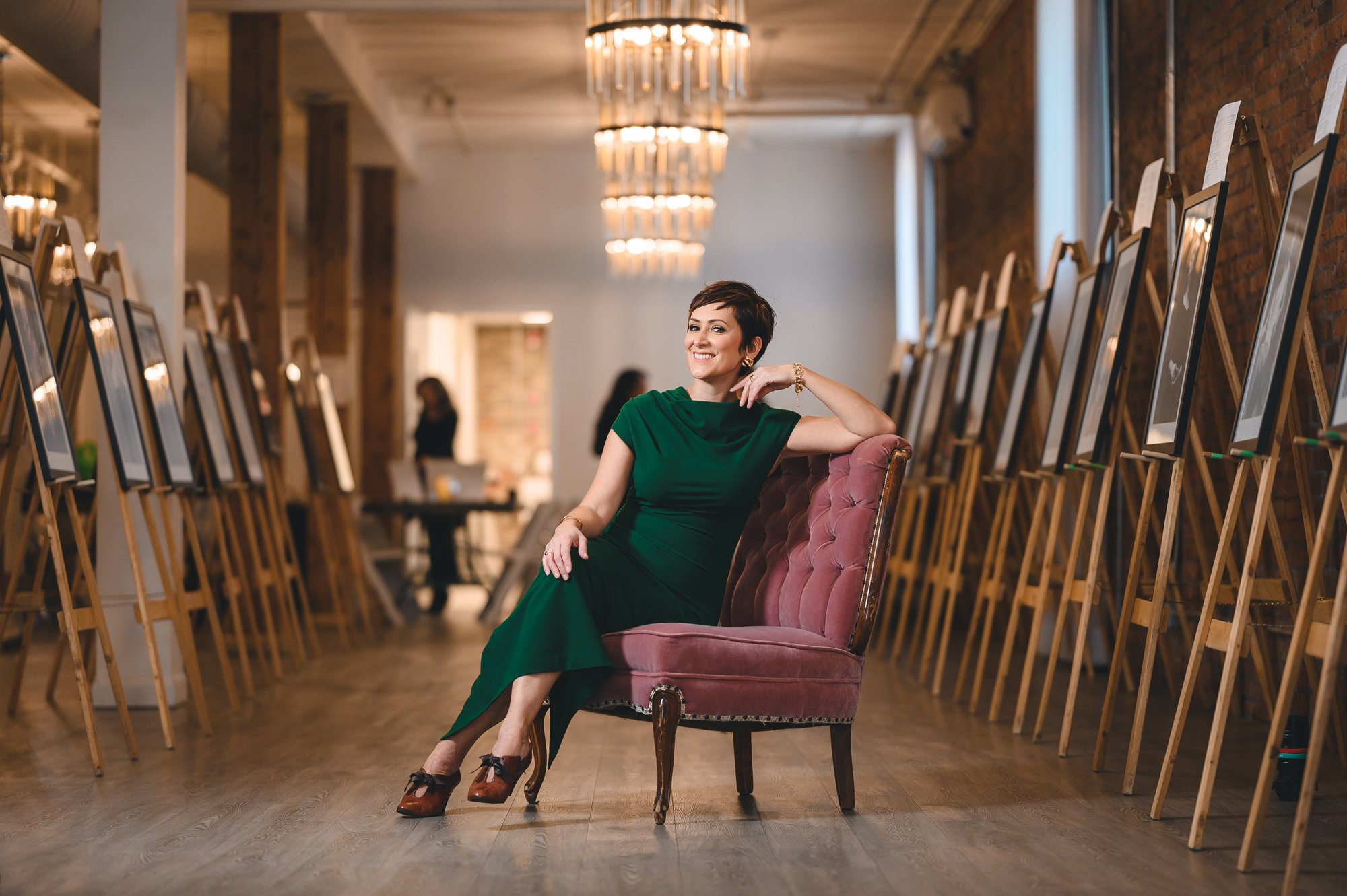 Calgary women and family portrait photographer at exhibit displaying framed fine art portraits