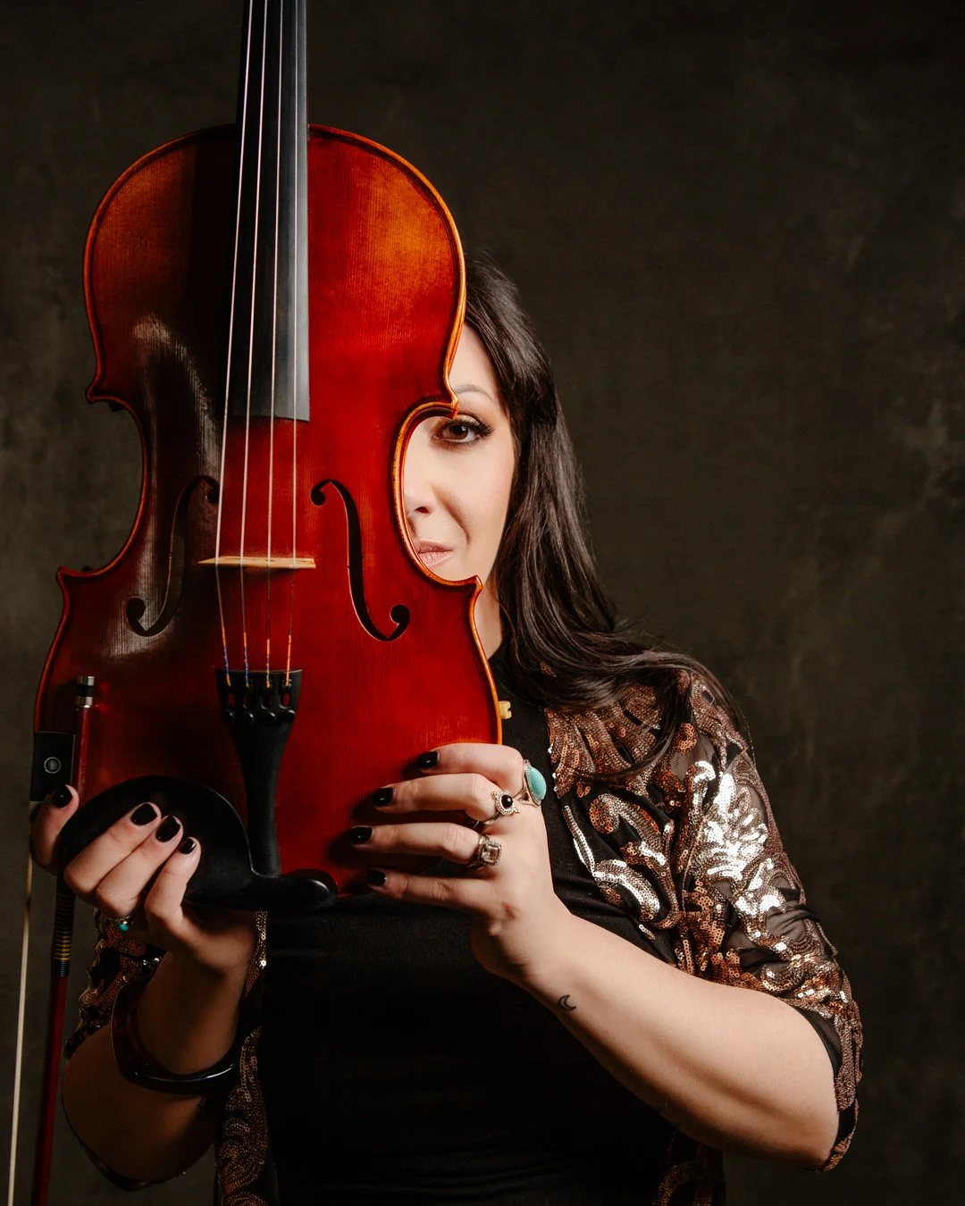 Moody, dramatic studio portrait of a violin player and instructor in Calgary, AB