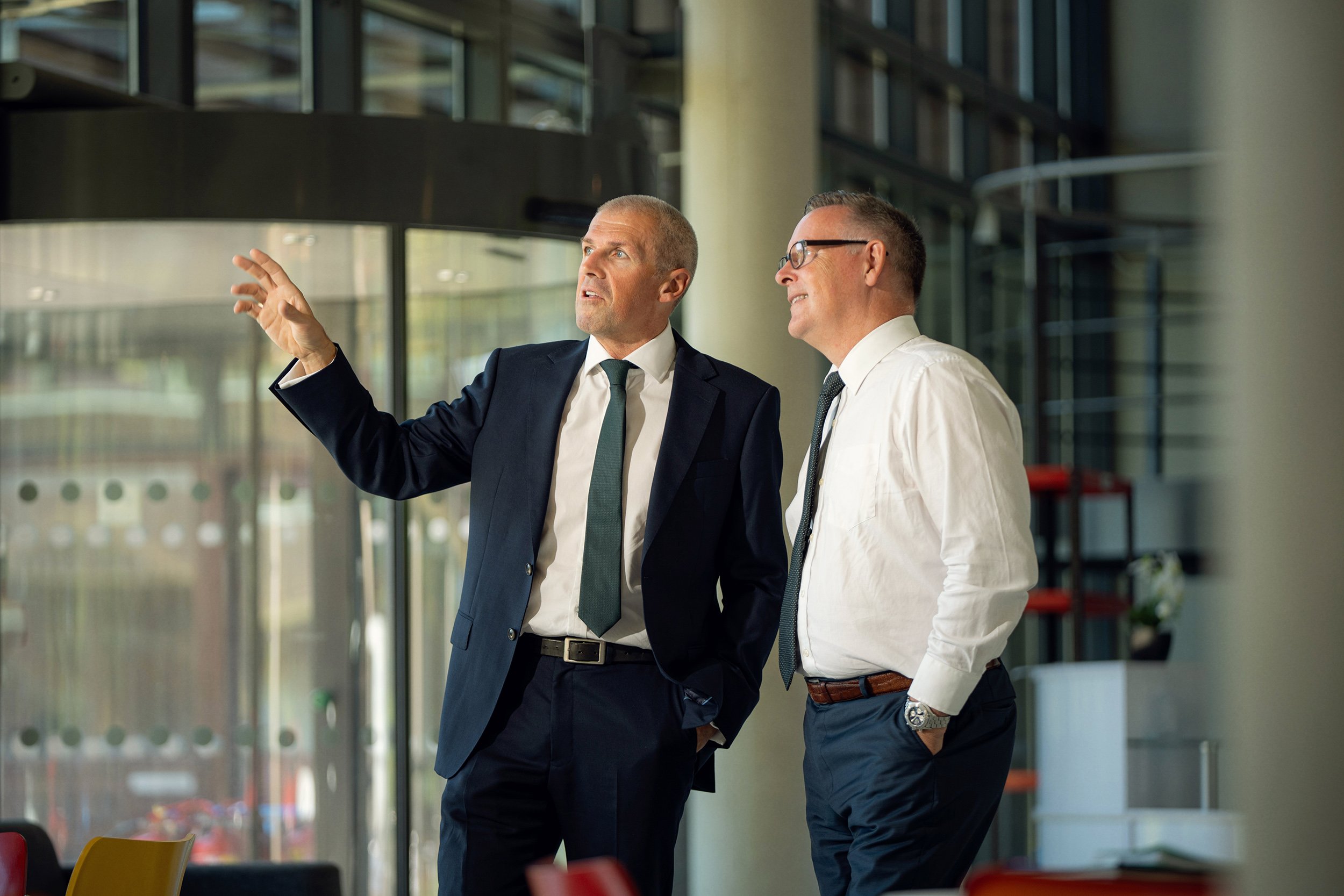 Corporate photography by Nathaniel Rosa - two businessmen talking to each other in a lobby copy.jpg