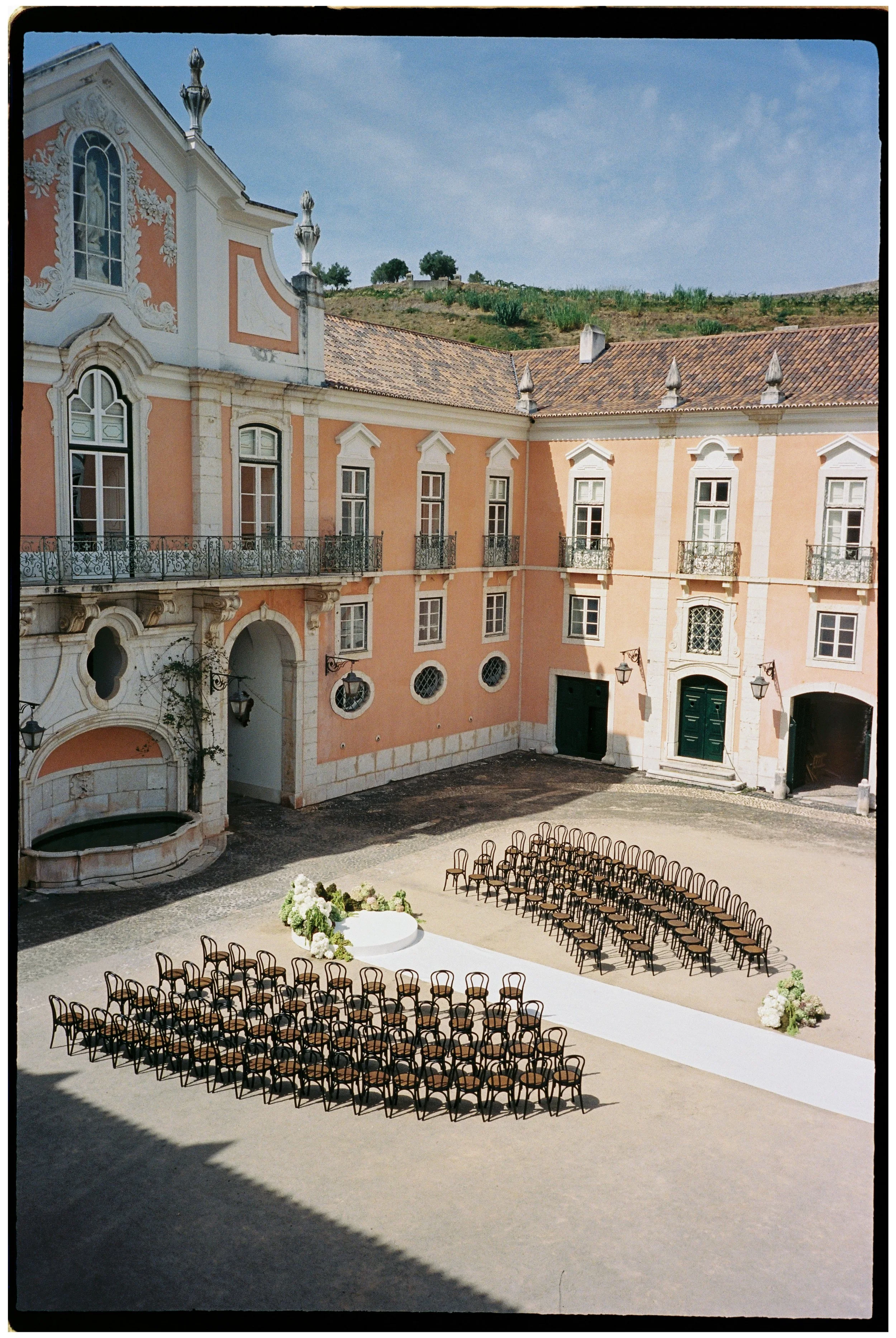 Outdoor wedding ceremony setup in the courtyard of Palácio do Correio-Mor near Lisbon, Portugal.