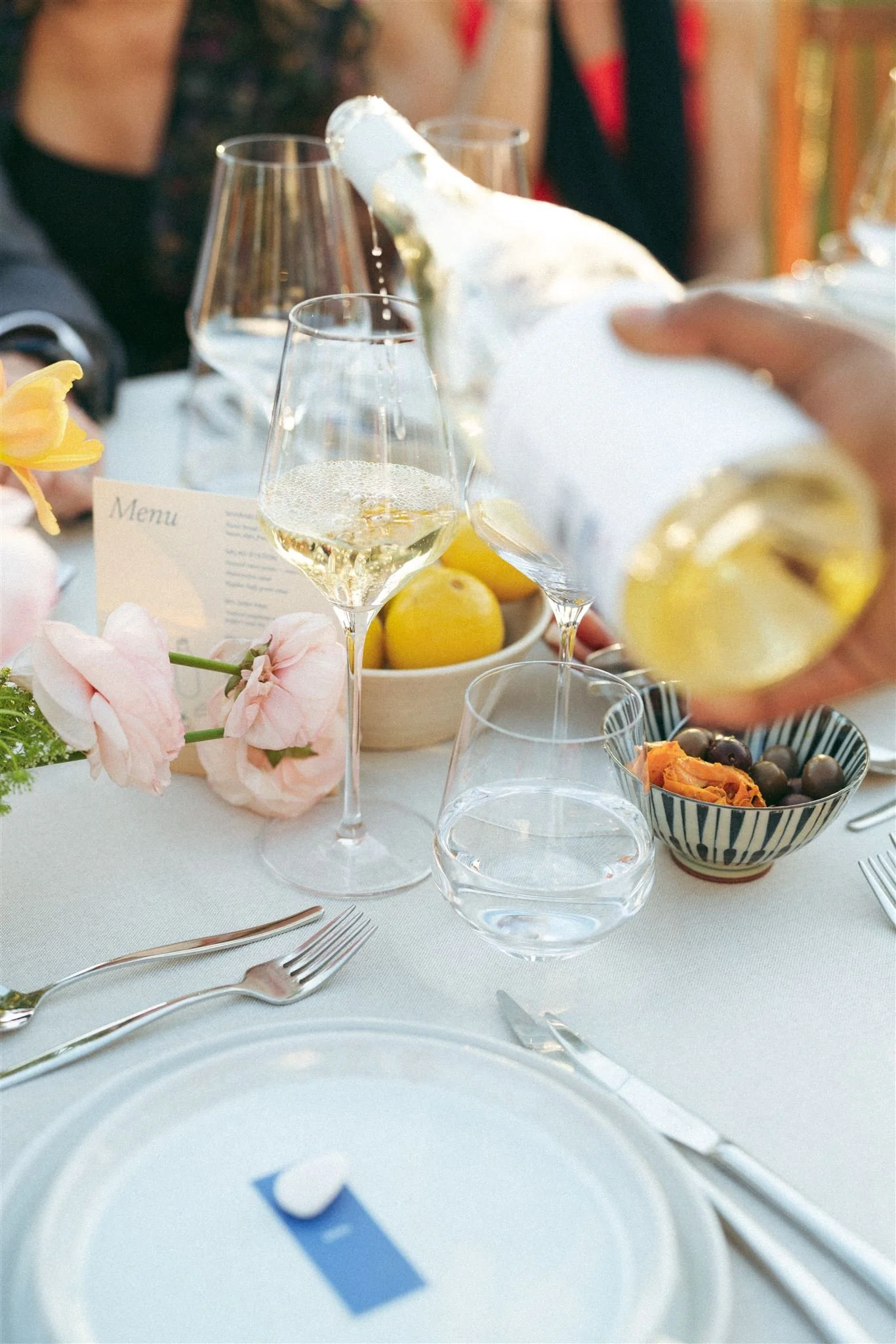 Wine being poured during a relaxed vineyard wedding dinner at Morgado do Quintão in the Algarve, Portugal.