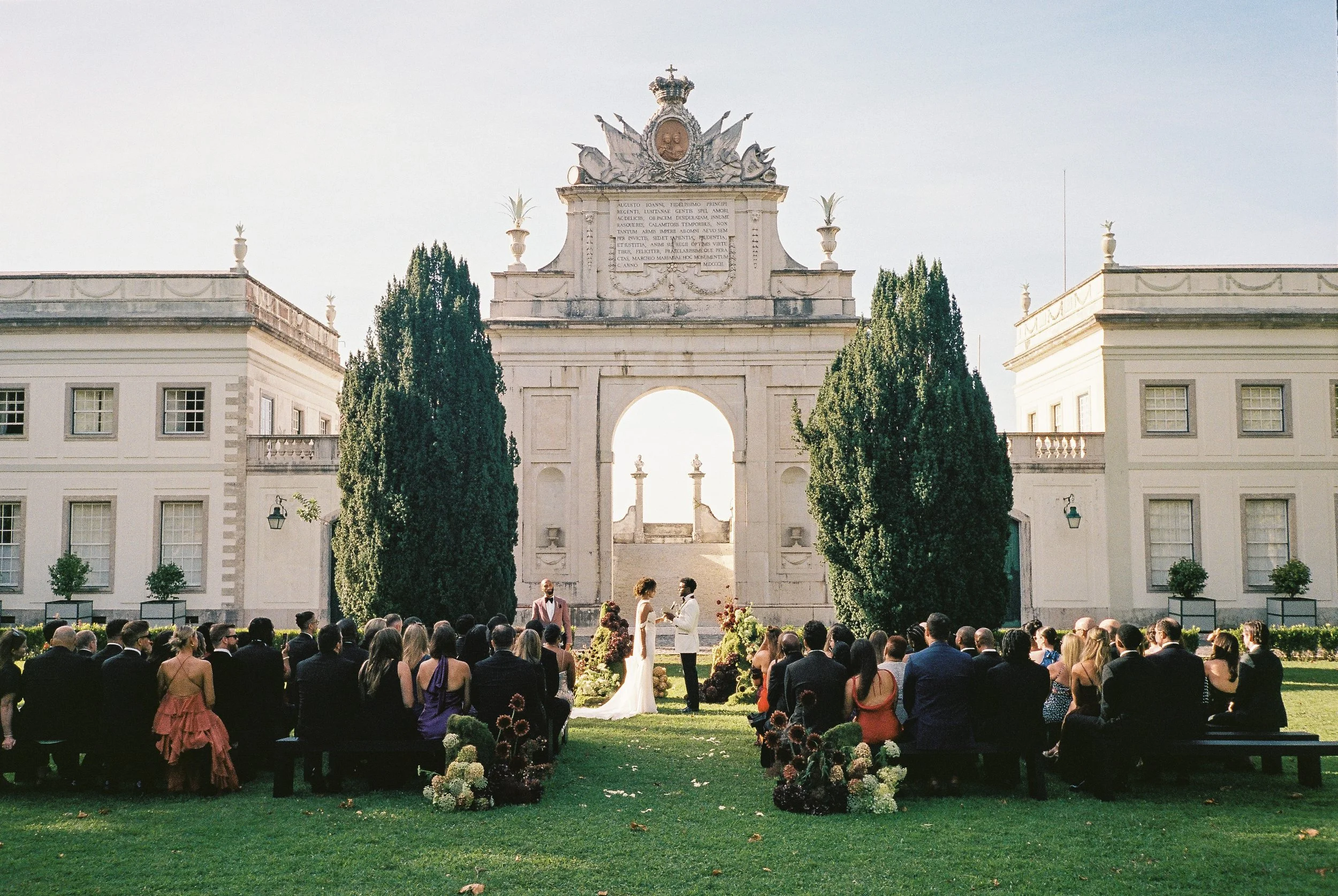 Outdoor wedding ceremony at Seteais Palace in Sintra with the iconic palace arch in the background.