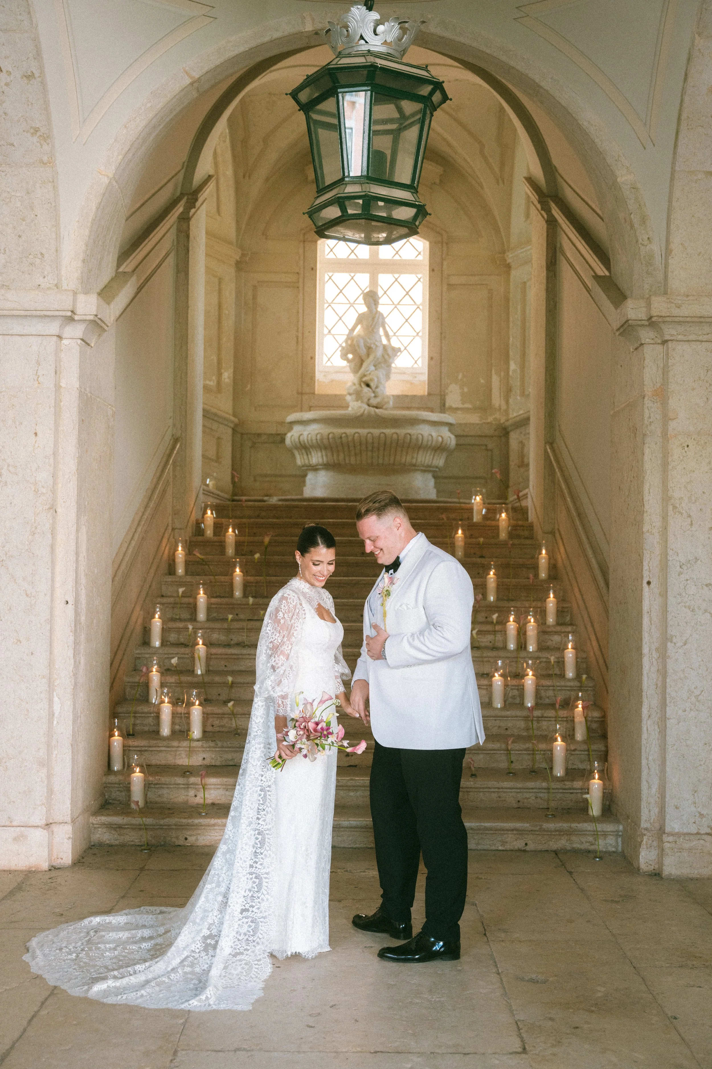 Bride and groom sharing a first look inside Palácio do Correio-Mor during their Lisbon destination wedding.
