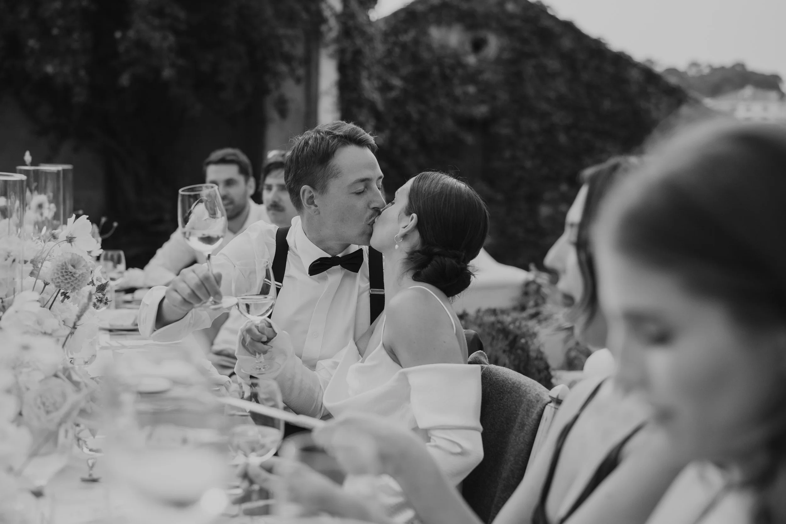 Bride and groom sharing a kiss at outdoor candlelit wedding dinner Quinta de Sant'Ana Portugal