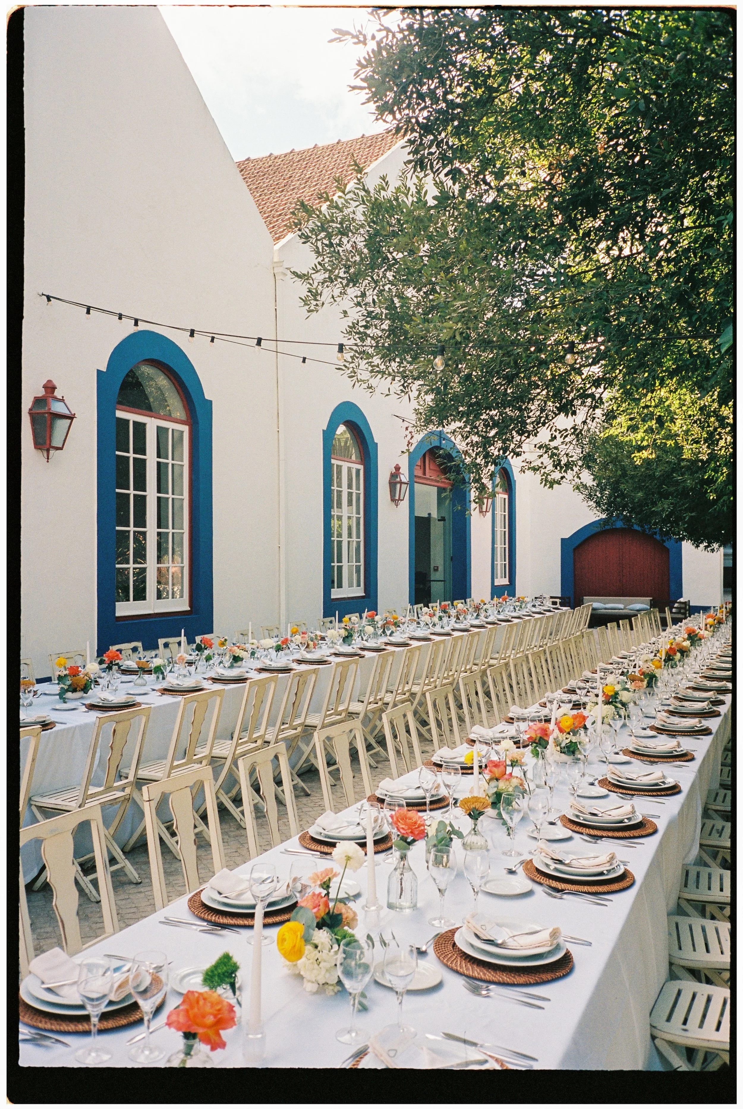 Outdoor wedding dinner table setup with flowers during an intimate destination wedding in Portugal