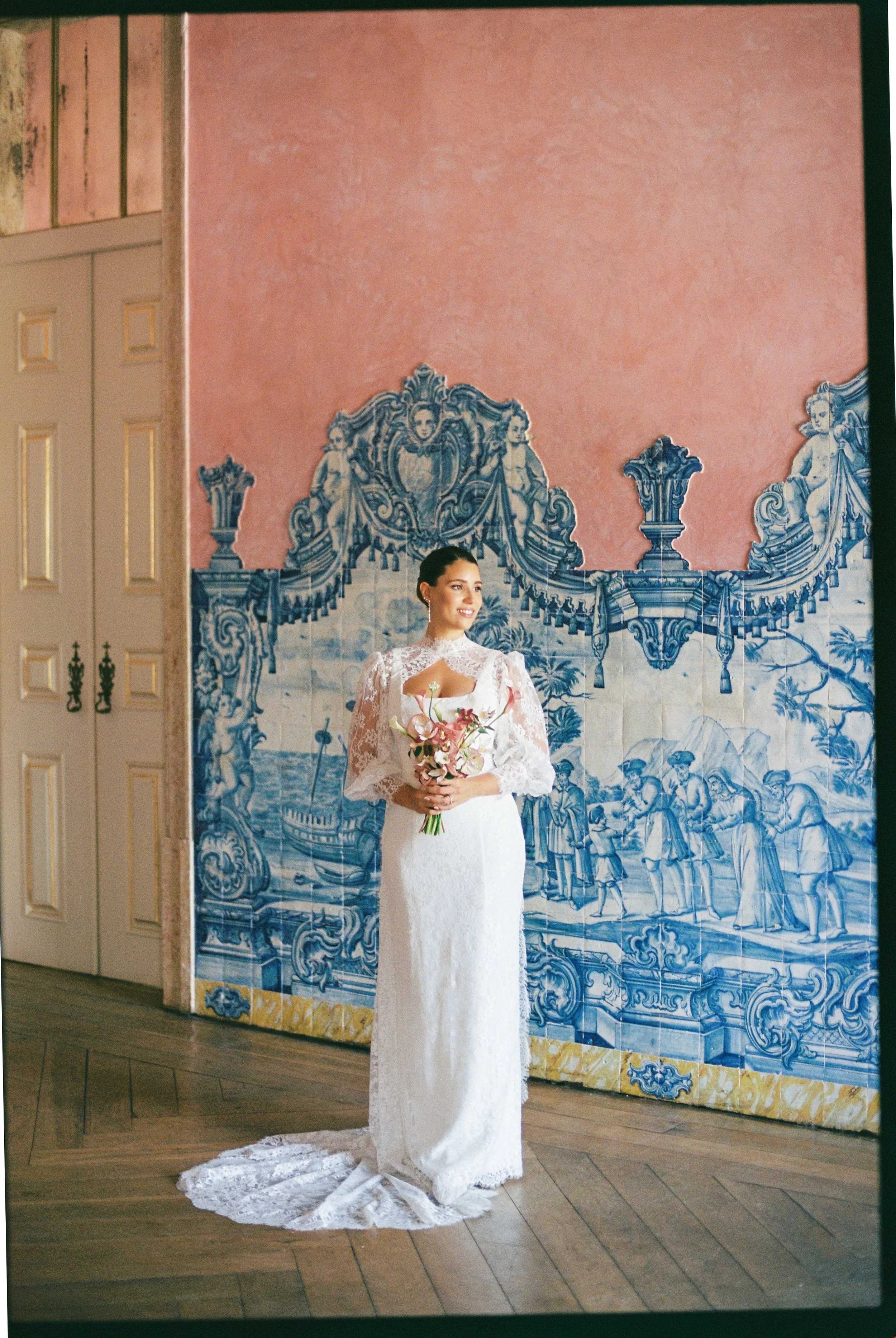Bride portrait in front of traditional Portuguese azulejo tiles at Palácio do Correio-Mor during a destination wedding near Lisbon.