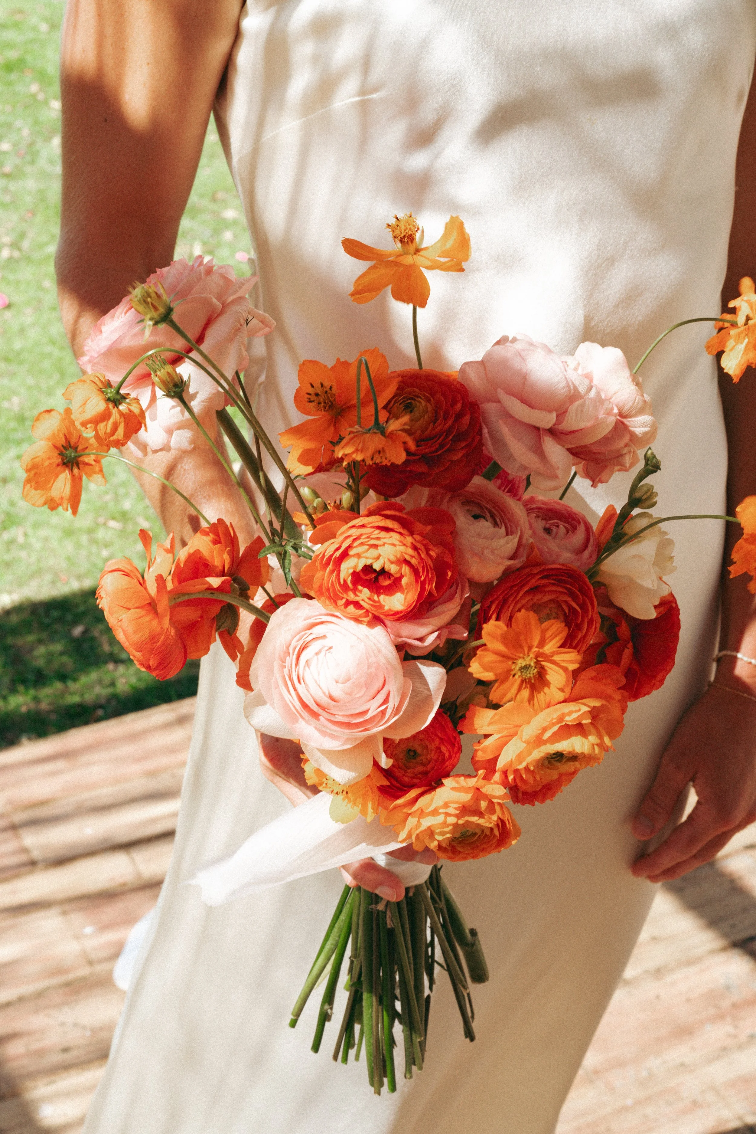 Close-up of orange and peach wedding bouquet at Morgado do Quintão in the Algarve, Portugal