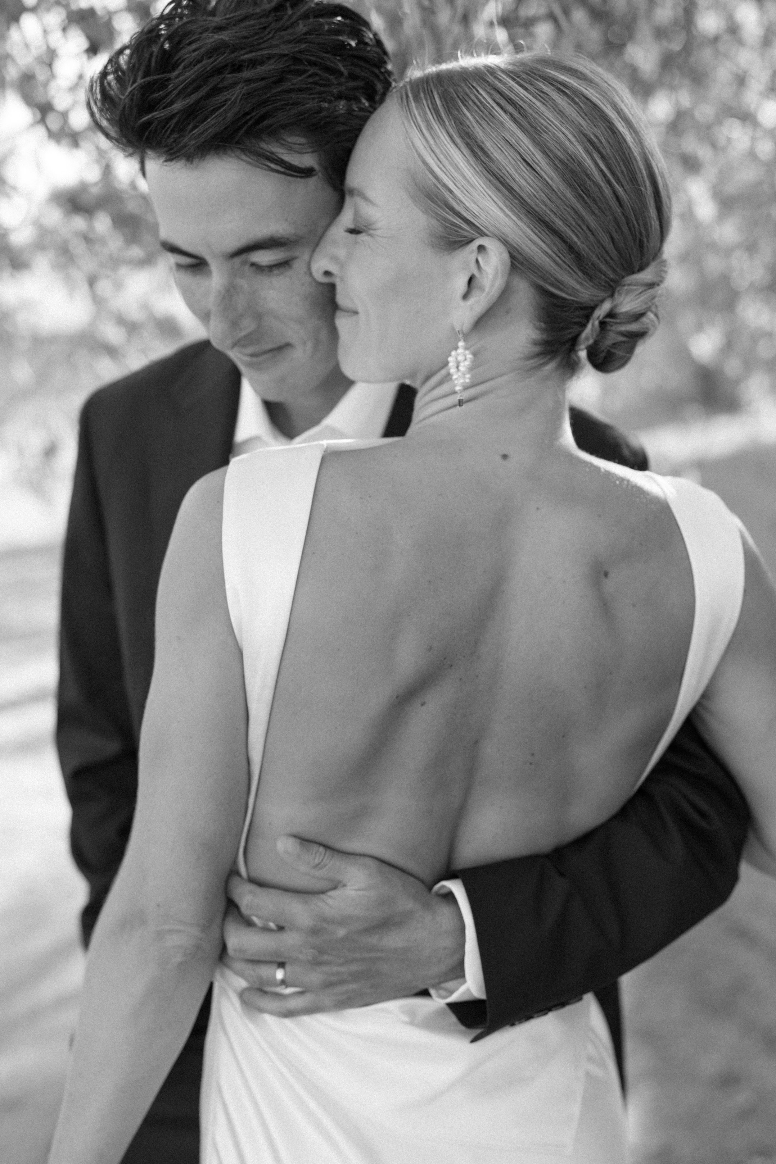 Black and white portrait of a bride and groom embracing during an intimate wedding at Morgado do Quintão in the Algarve.