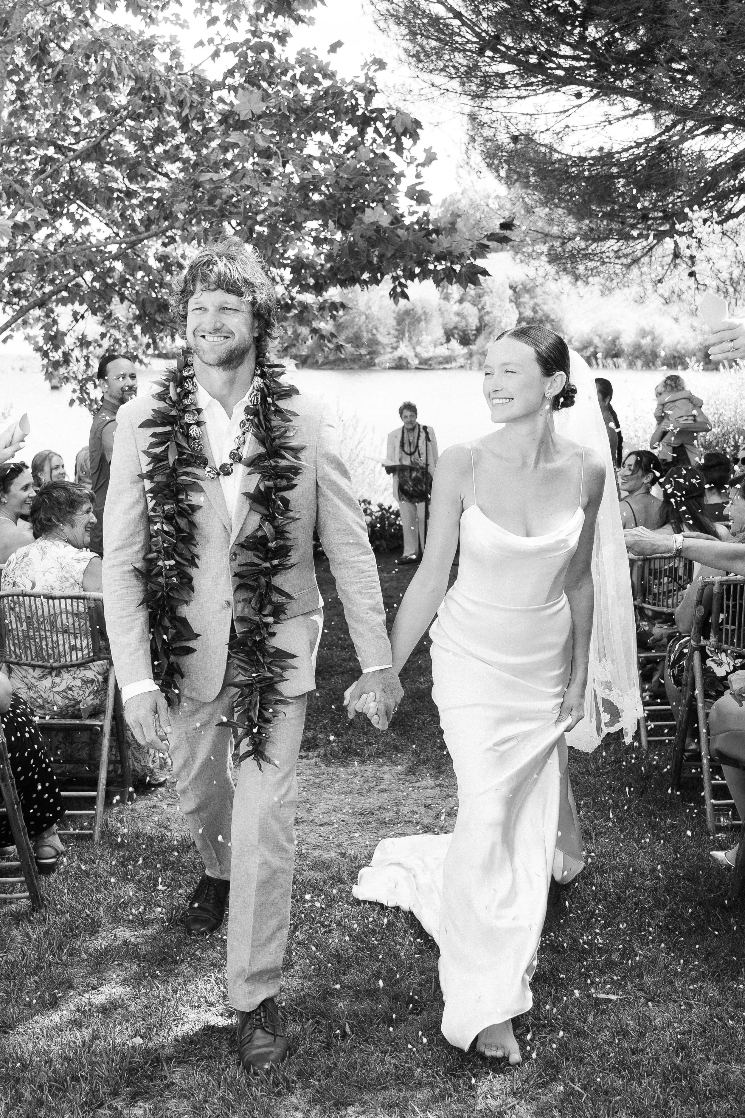 Bride and groom walking barefoot after their ceremony during an intimate destination wedding in Portugal