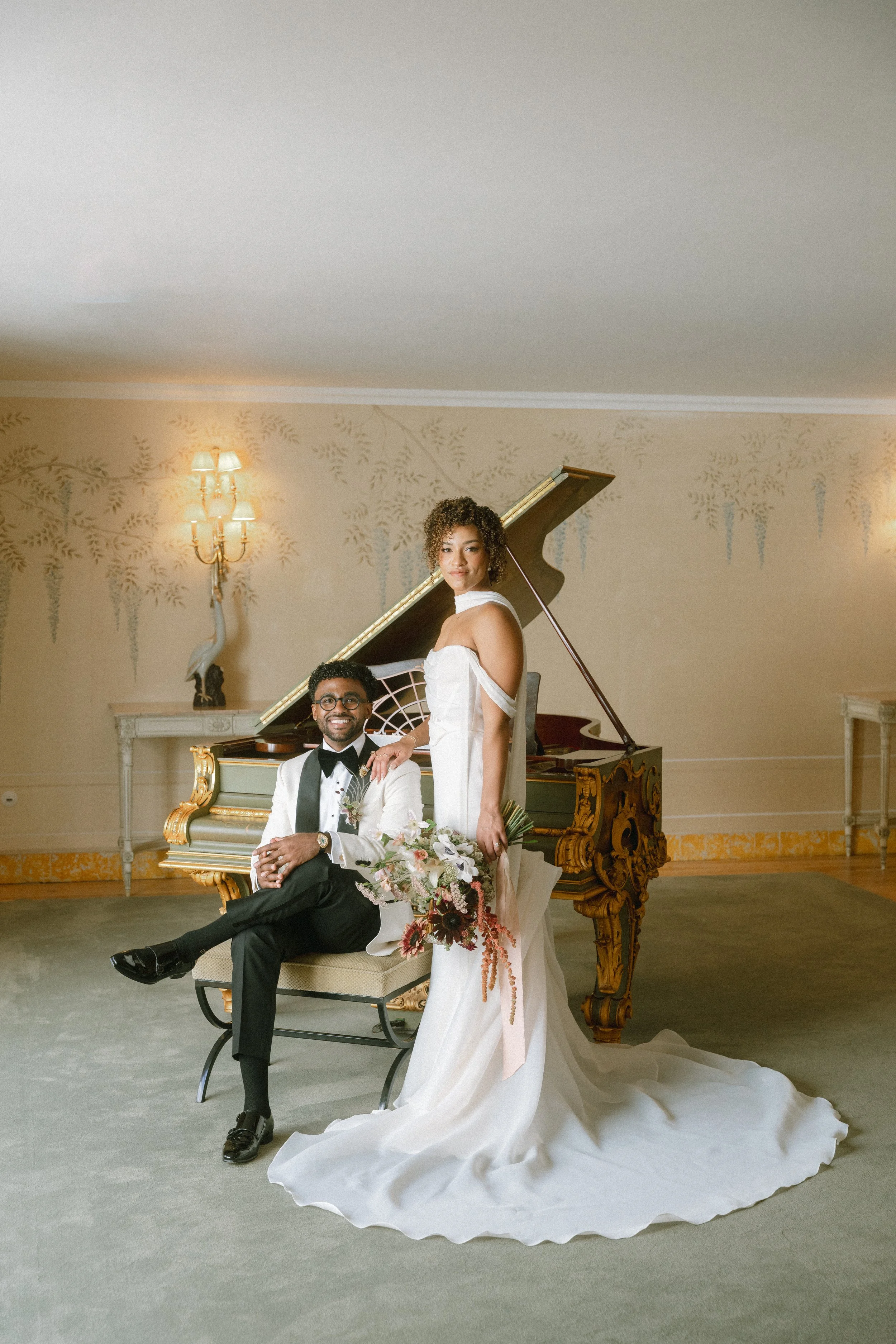 Bride and groom portrait beside a grand piano inside Seteais Palace during an elegant Sintra wedding in Portugal.