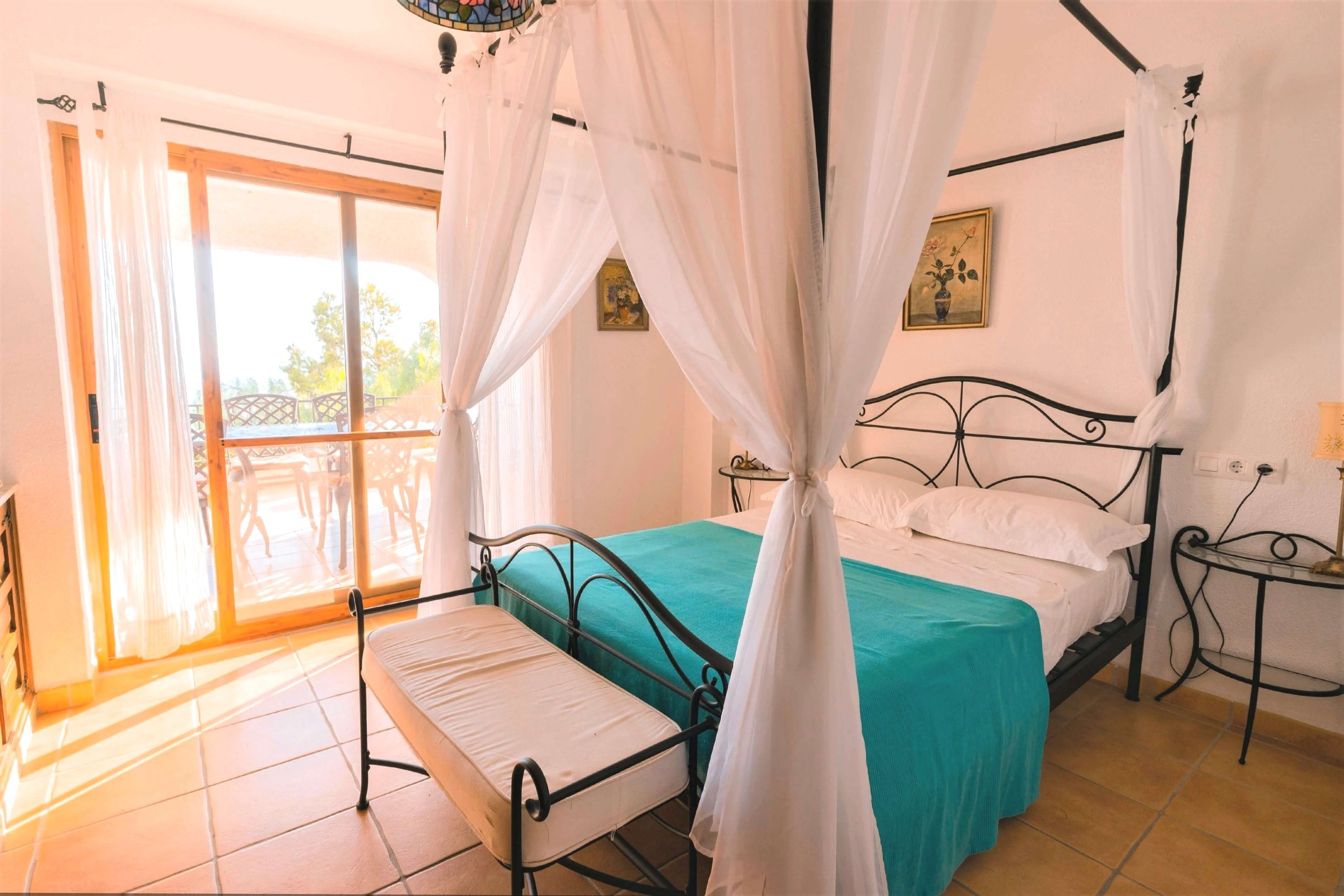 Master Bedroom with four poster bed and private balcony offering a relaxing retreat