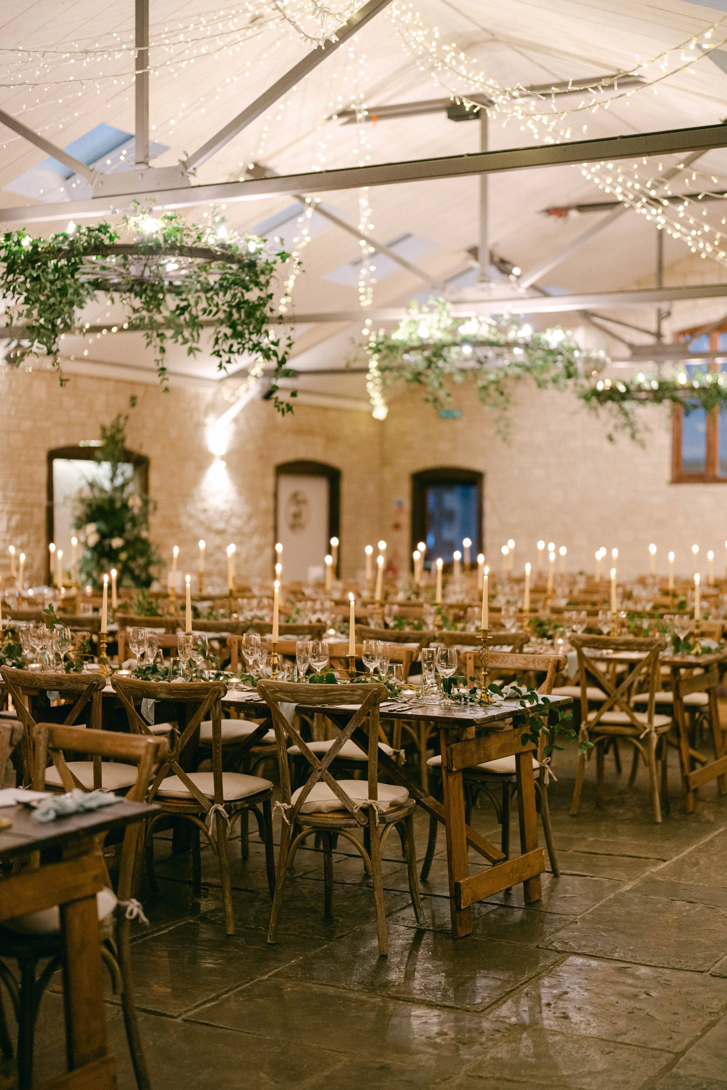 Bride and groom walking holding hands  through stone courtyard