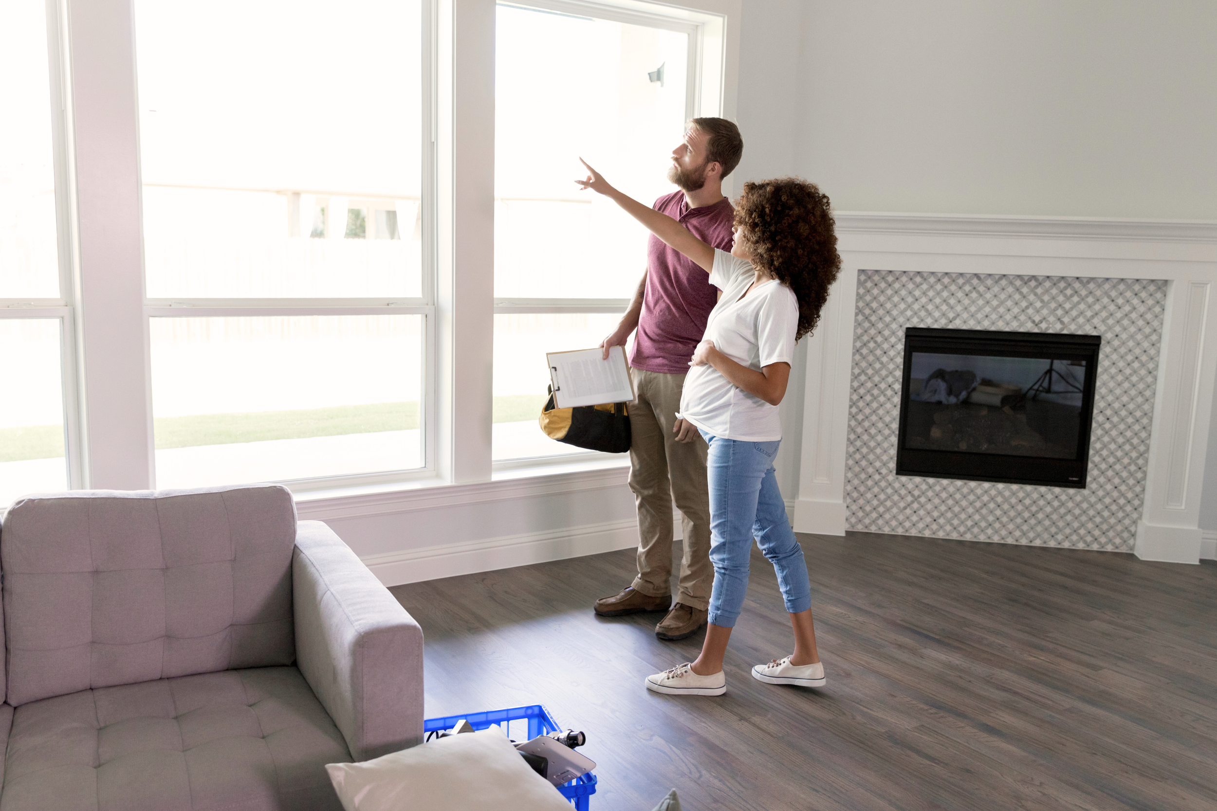 A pregnant woman assessing her home with a contractor.