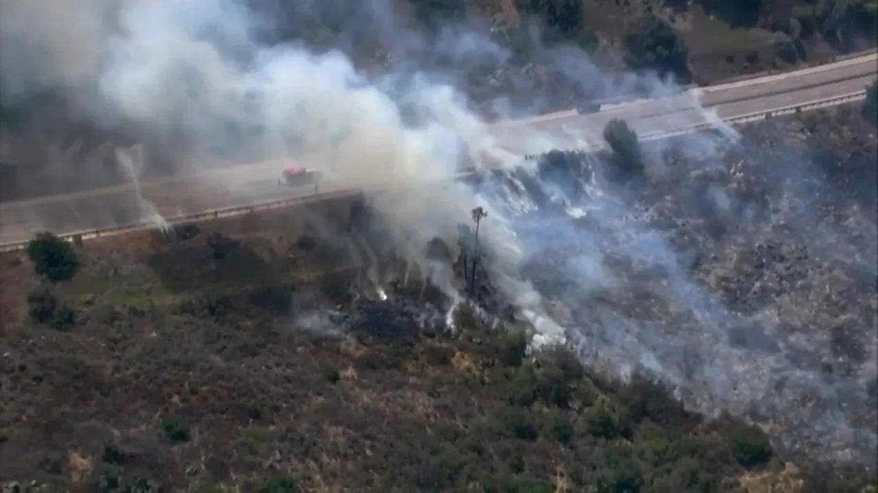 Wildfire smoke covers a residential area as residents evacuate.