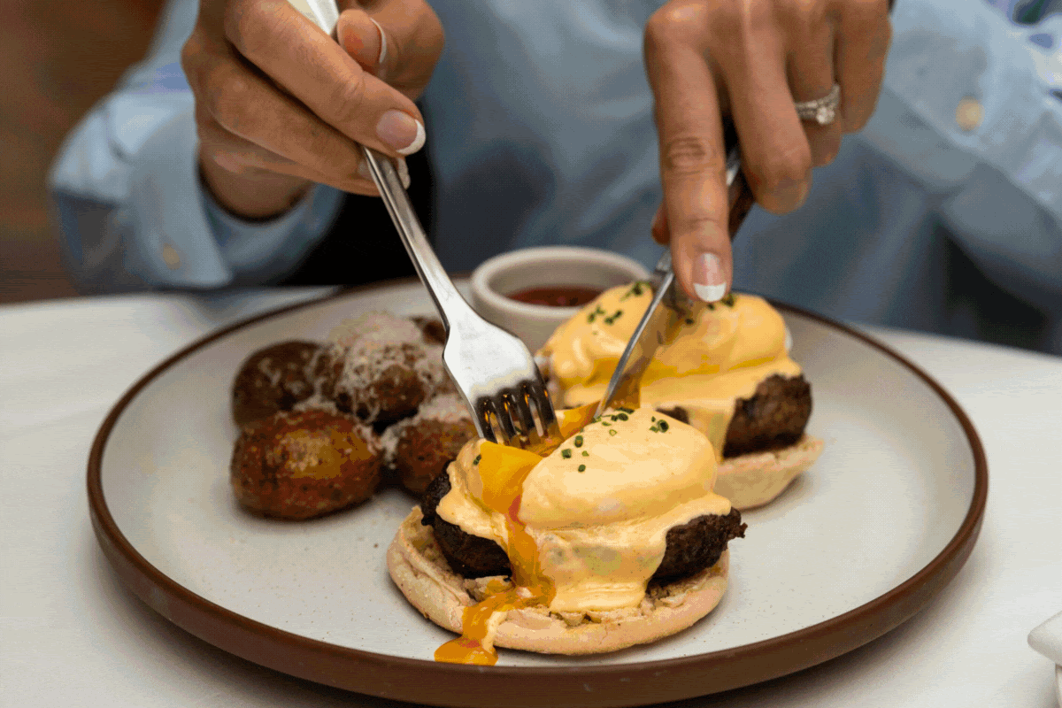 Looping Gif showcasing a man scooping gelato, a photo of rows of fresh sushi, eggs benedicte, a photo of a mom with her daughter smiling at a table with a white tablecloth and people in the background, and a dining room with wine and flowers