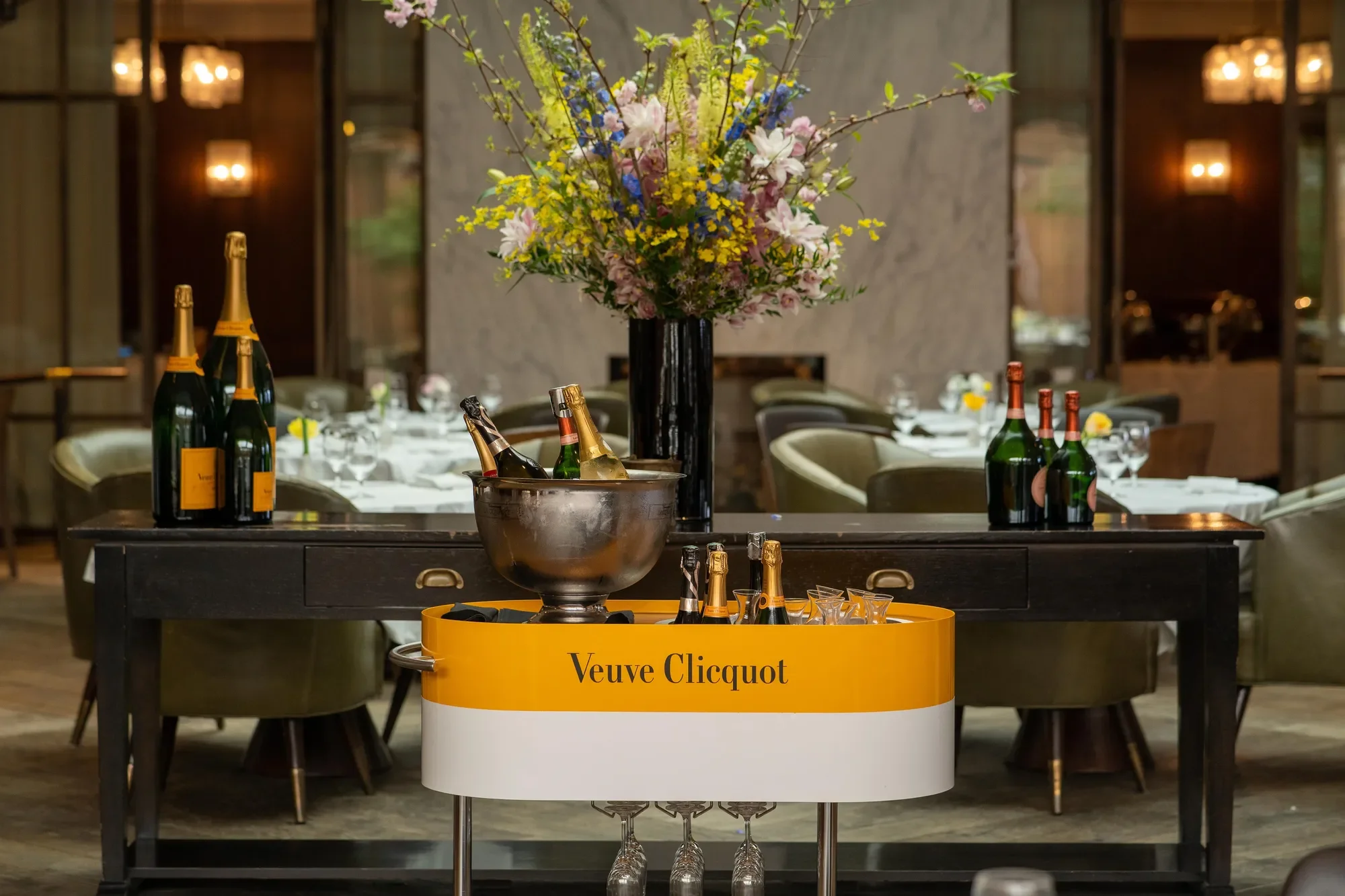 elegant display of champagne in front of colorful bouquet