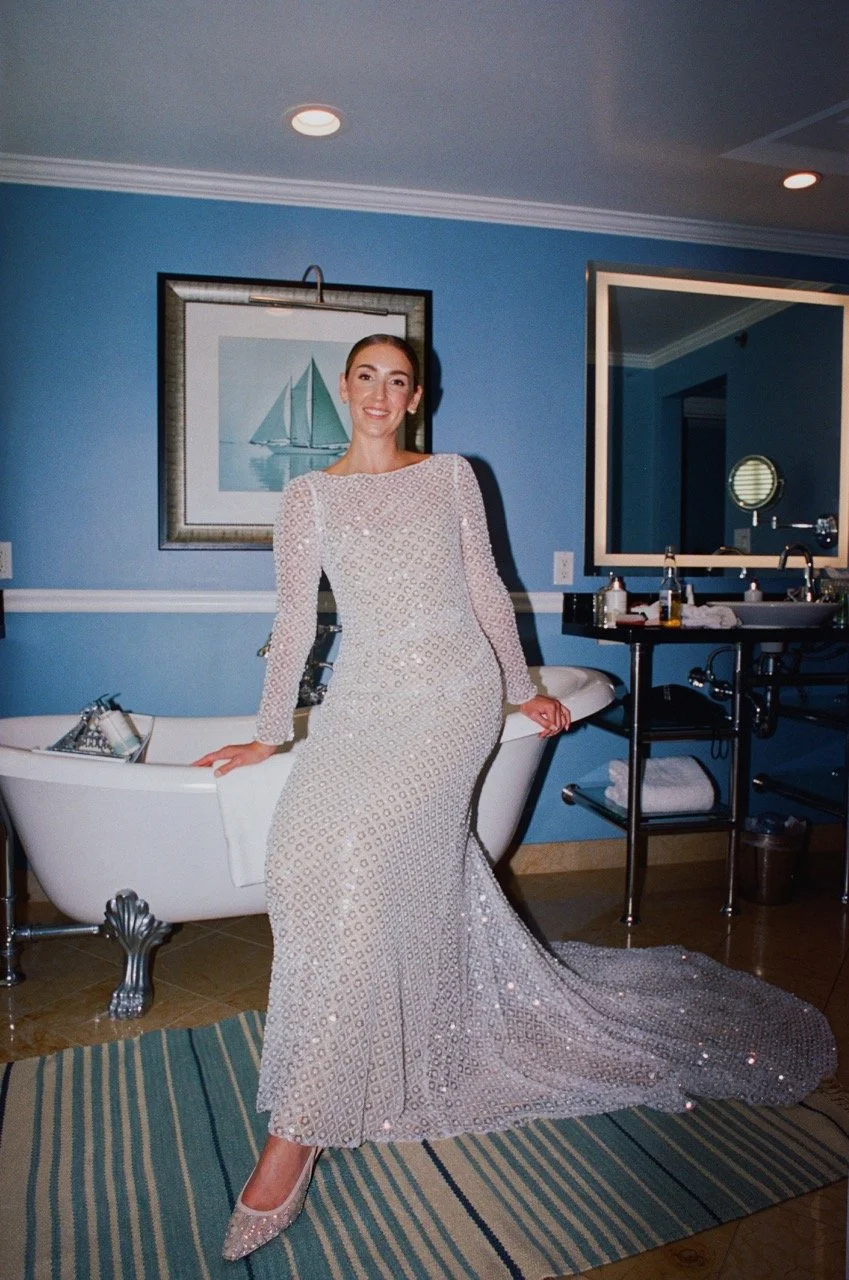 woman-in-sparkly-dress-poses-in-blue-room.jpeg