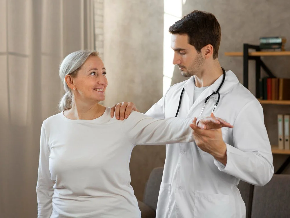 A doctor performing a physical exam on an older woman in a medical office.