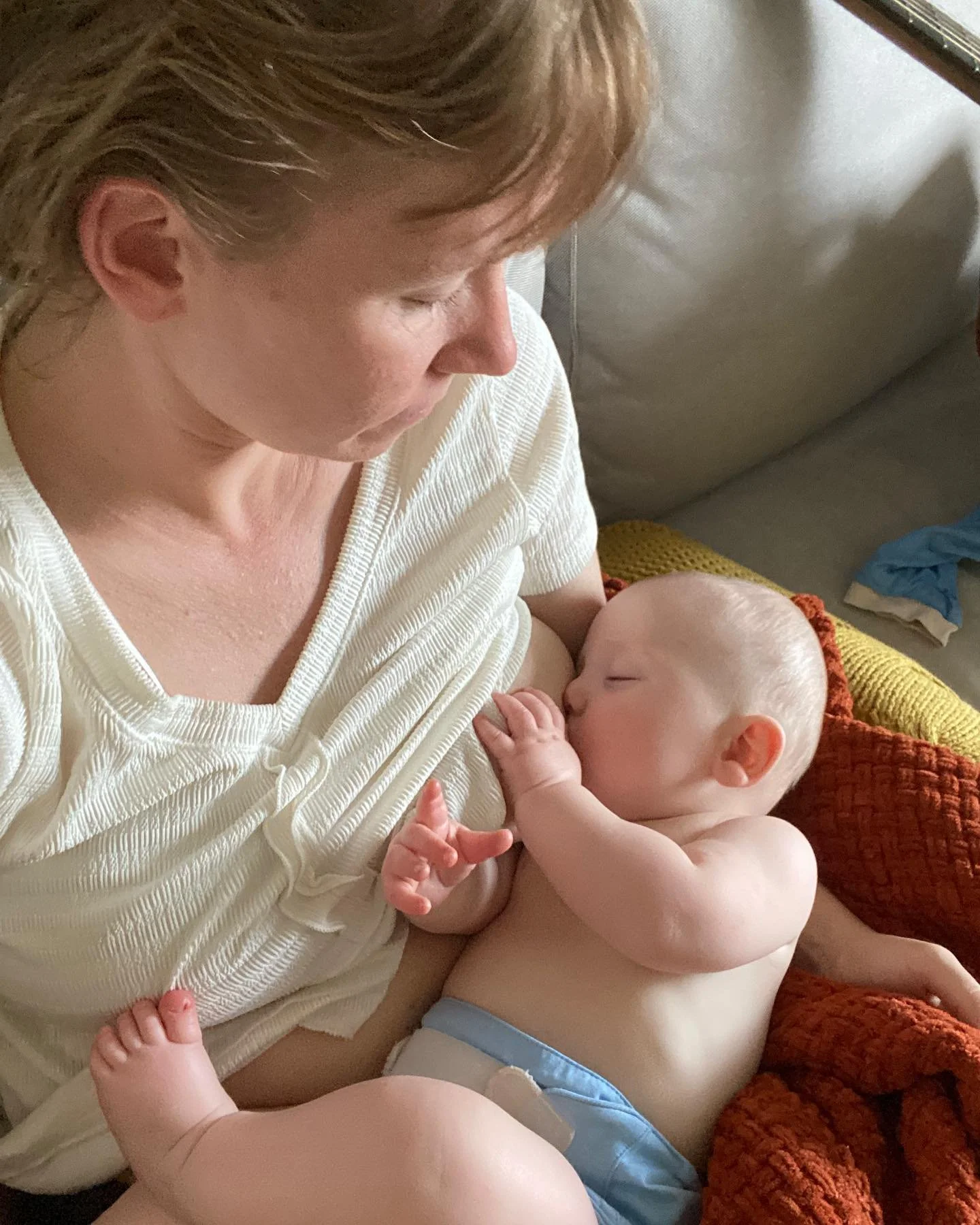 GOOD MOTHER

Through the window of morning, the round height of your forehead lights up, a pale autumn lantern above the shadow of yesterday.
This softest part of you that squeezed through me and unto earth,
where bones have not yet set,
beats s