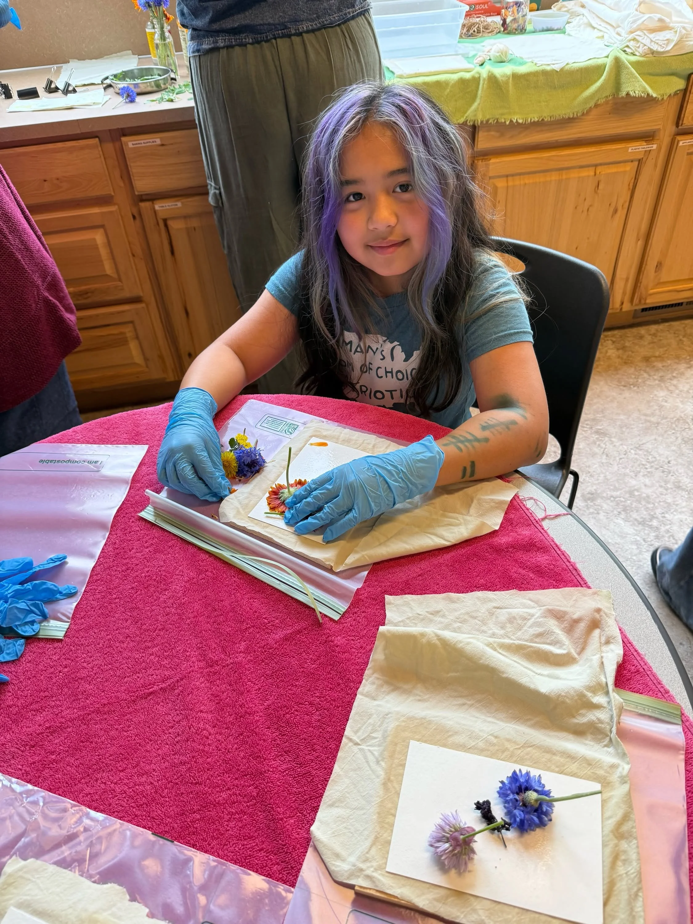an OP girl making art with flowers and paint