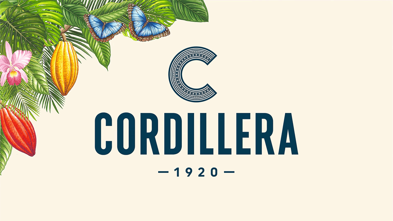 A logo for Cordillera, established in 1920, featuring tropical leaves, colorful flowers, cocoa pods, and two blue butterflies in the top left corner on a beige background.