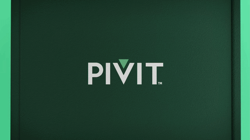 Close-up of a green wall with the word 'PIVIT' in white letters and a green downward arrow replacing the letter 'V'.