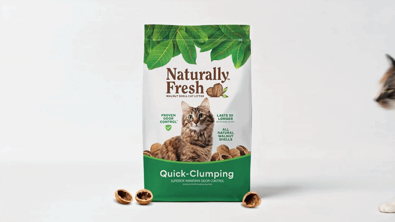 A bag of Naturally Fresh walnut shell cat litter labeled 'Quick-Clumping' with a cat image on the front, surrounded by walnut shells, partially visible on the right side.