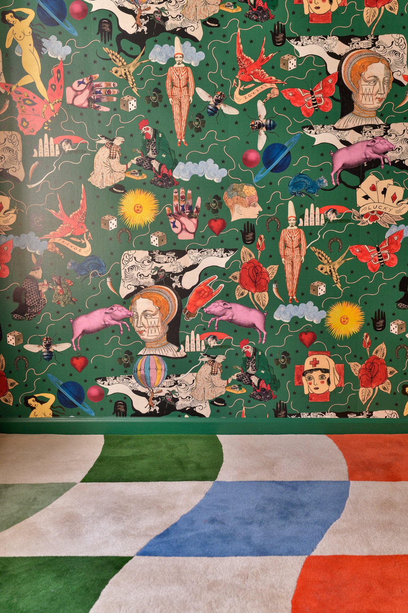 Raucous Alice in Wonderland-themed wallpaper was specifically chosen by the clients—an eye-catching, whimsical addition.