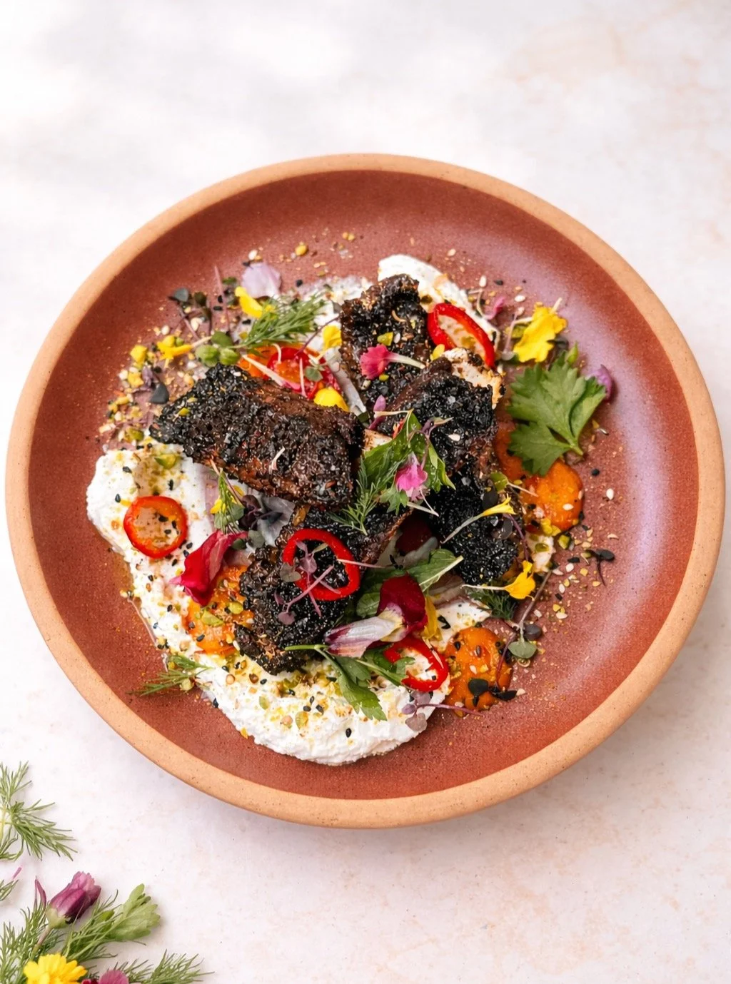 Seattle Lamb Jam 2026 🐑🔥 Running the month of April for Dinner:
Grilled lamb ribs, lacquered and charred.
Set over labneh with rhubarb amba, 
pickled fresno, and green harissa oil.
Finished with herbs, flowers, and pistachio.
Spring meets fire: Com