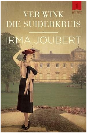 A woman standing on a lawn in front of a large historic building, wearing a hat and vintage clothing, with trees around her.