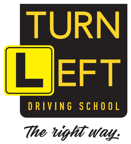 Sign for driving school with yellow and black color scheme that says 'Turn Left' and 'Driving School' and 'The right way.'