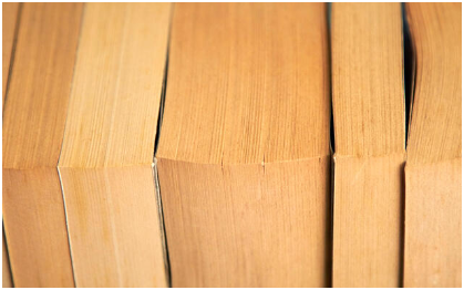Close-up of several stacked wooden planks or boards.