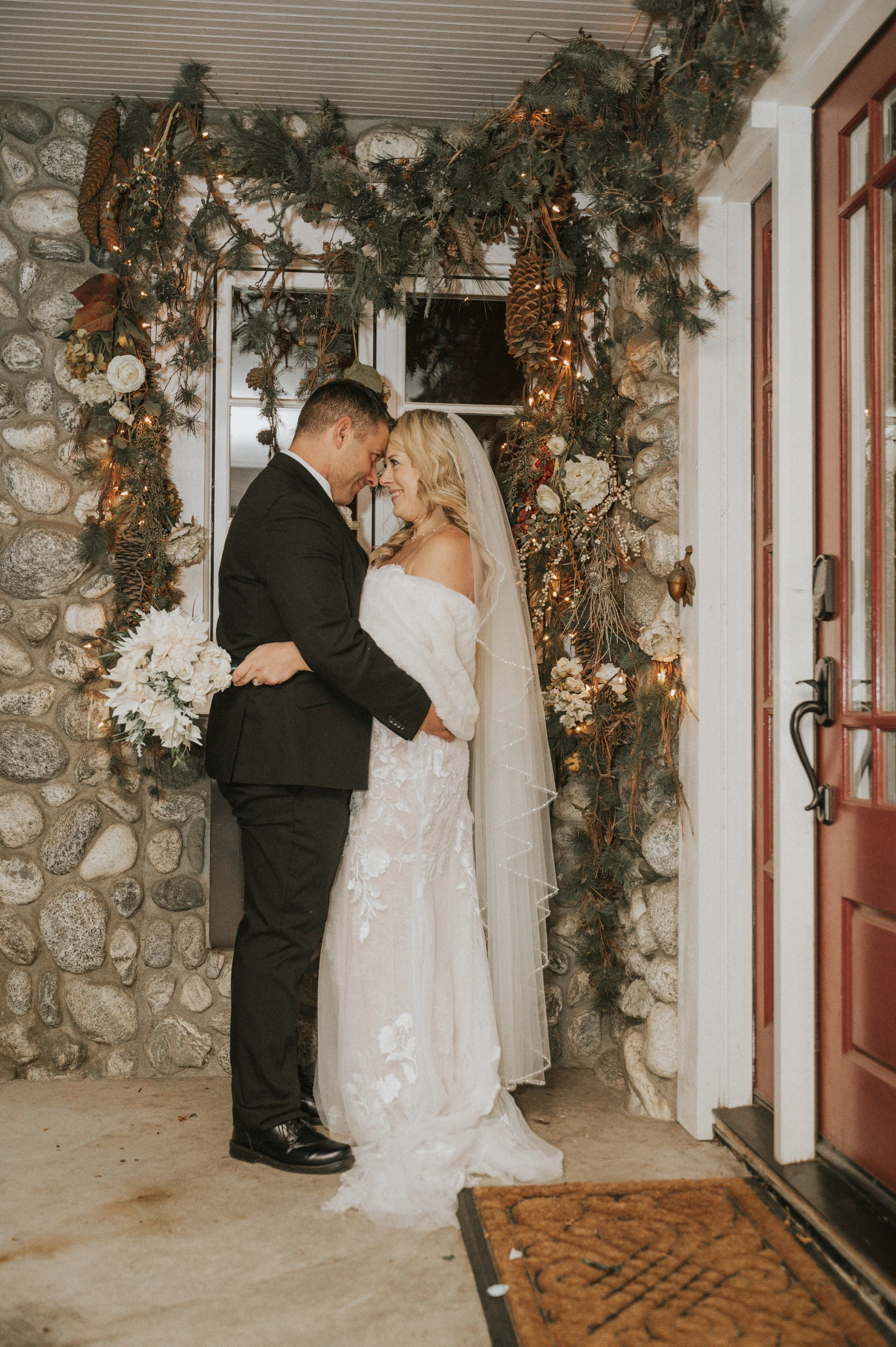 **Title:** Hallmark Romance: Newlyweds Captured by Michelle Howell in Front of a Decorated Window
**Meta Description:** Step into a scene straight out of a Hallmark movie as a newlywed couple poses in front of a beautifully decorated window, expertl